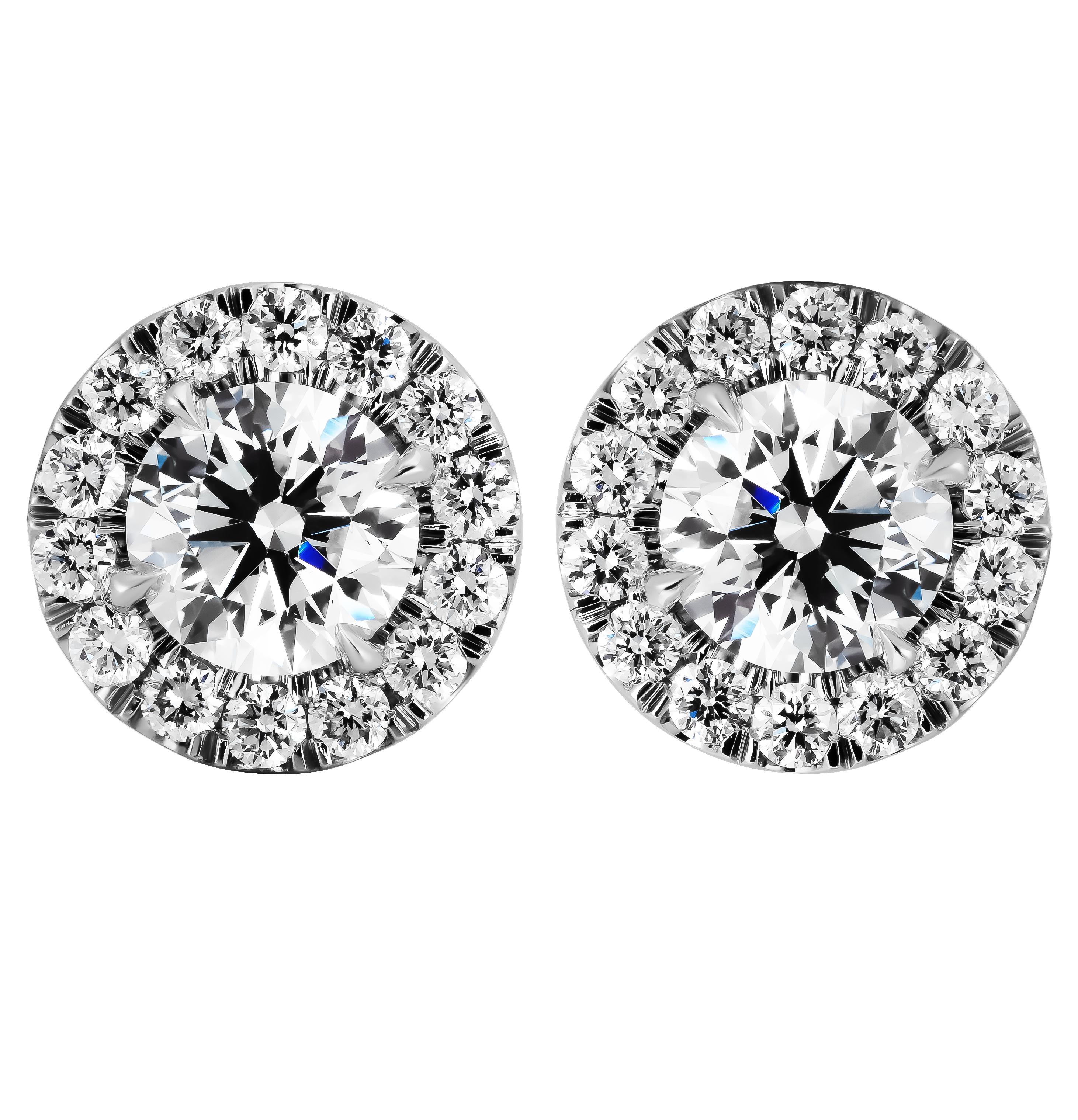 GIA Certified Classic halo studs in Platinum
Center Stones are:
0.83ct G VS2 Round shape diamond GIA#7482786198
0.86ct G VS1 Round shape diamond GIA#6482774929\

Total carat weight of the stones in halo: 0.69ct
