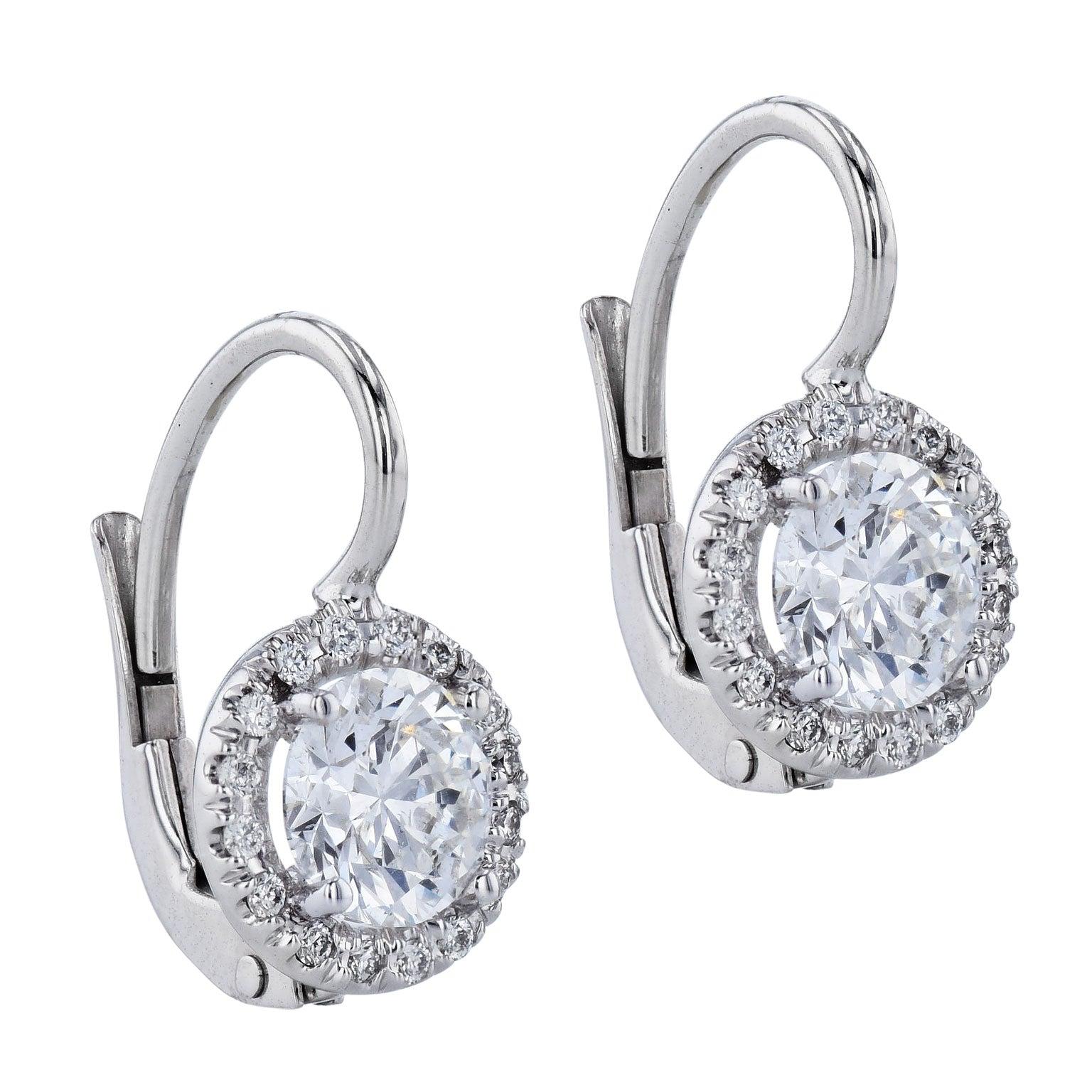 These stunning earrings are beautifully handcrafted in 18 karat white gold. 
The center stones are a total of 1.23 carats. They are G in color and SI2/I1 in clarity. 
Both stones are GIA certified.  
(0.61ct GIA#2215317298 & 0.62ct