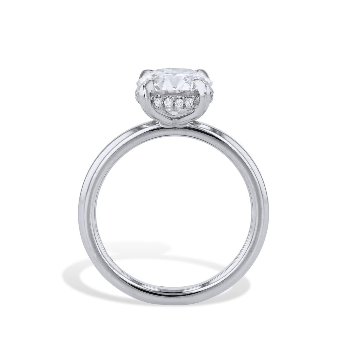 Experience luxurious brilliance with this extraordinary Round Diamond Platinum Engagement Ring. Adorned with a magnificent  round diamond at the center, it's complemented by a dazzling diamond pave underneath the basket. This one-of-a-kind piece is