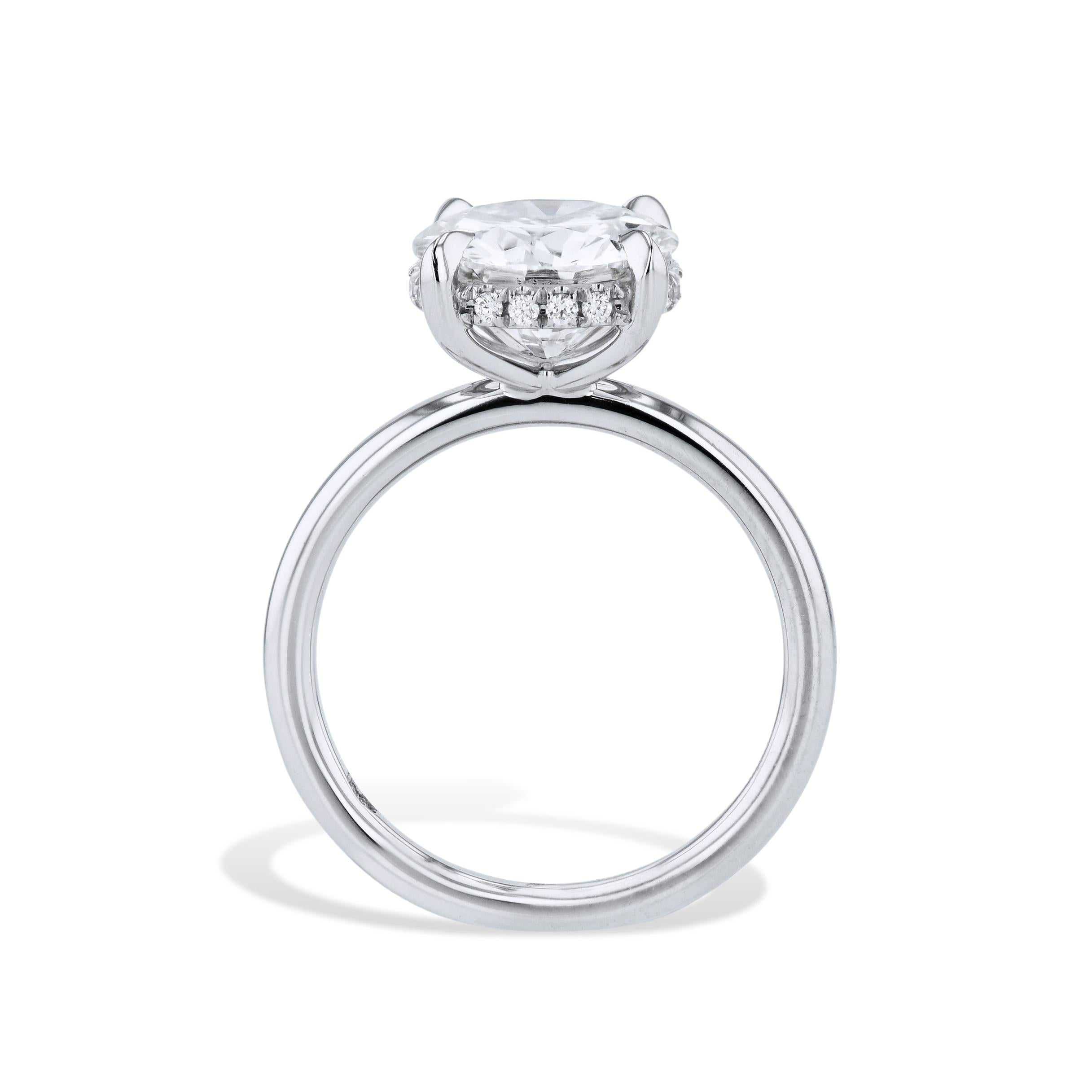 A dazzling 3.11 carat Round Brilliant Cut diamond, GIA # 5212971001, awaits at the center of this glamorous engagement ring. With sixteen handcrafted pave diamonds around the basket in G in color, VS1 in clarity, this Platinum ring is a must-have