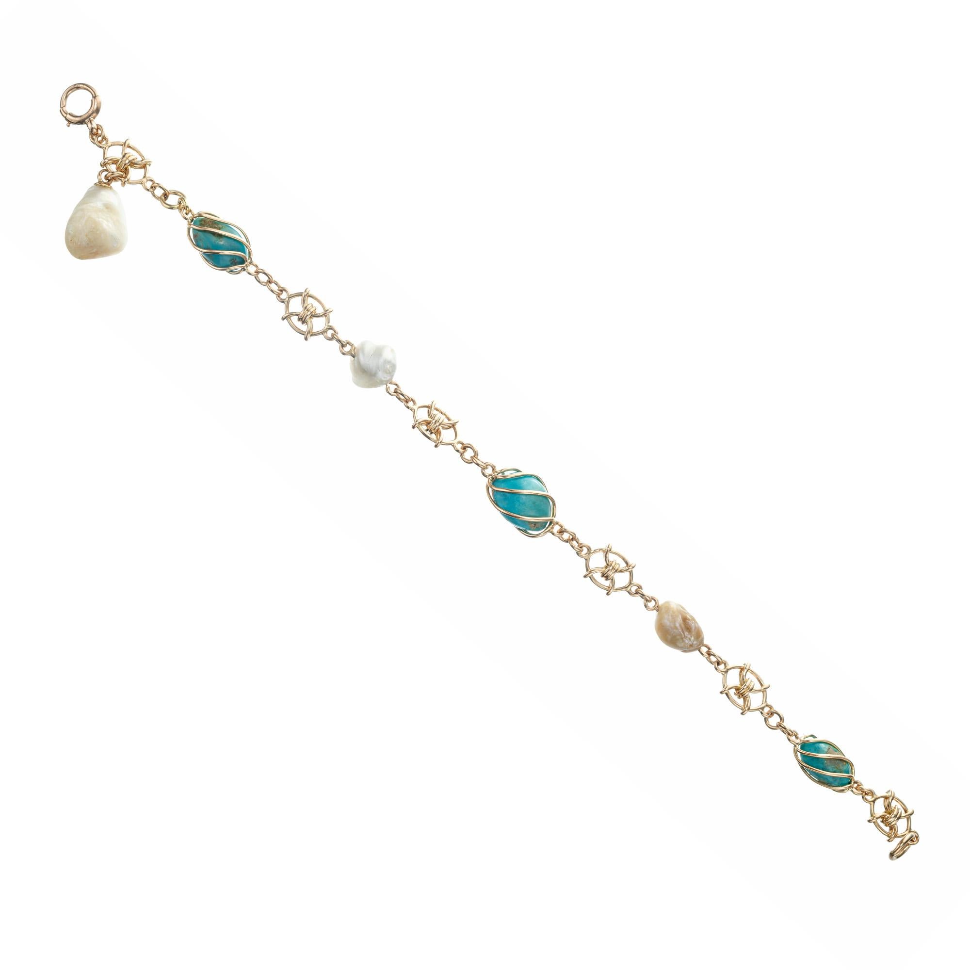 GIA certified Original American Arts & Crafts 1895 handmade 14k yellow gold bracelet with natural freshwater pearls and natural Turquoise. 8.25 inches in length. 

1 natural freshwater pearl, 11.0 x 8.66mm, GIA certificate #2175433383
2 natural