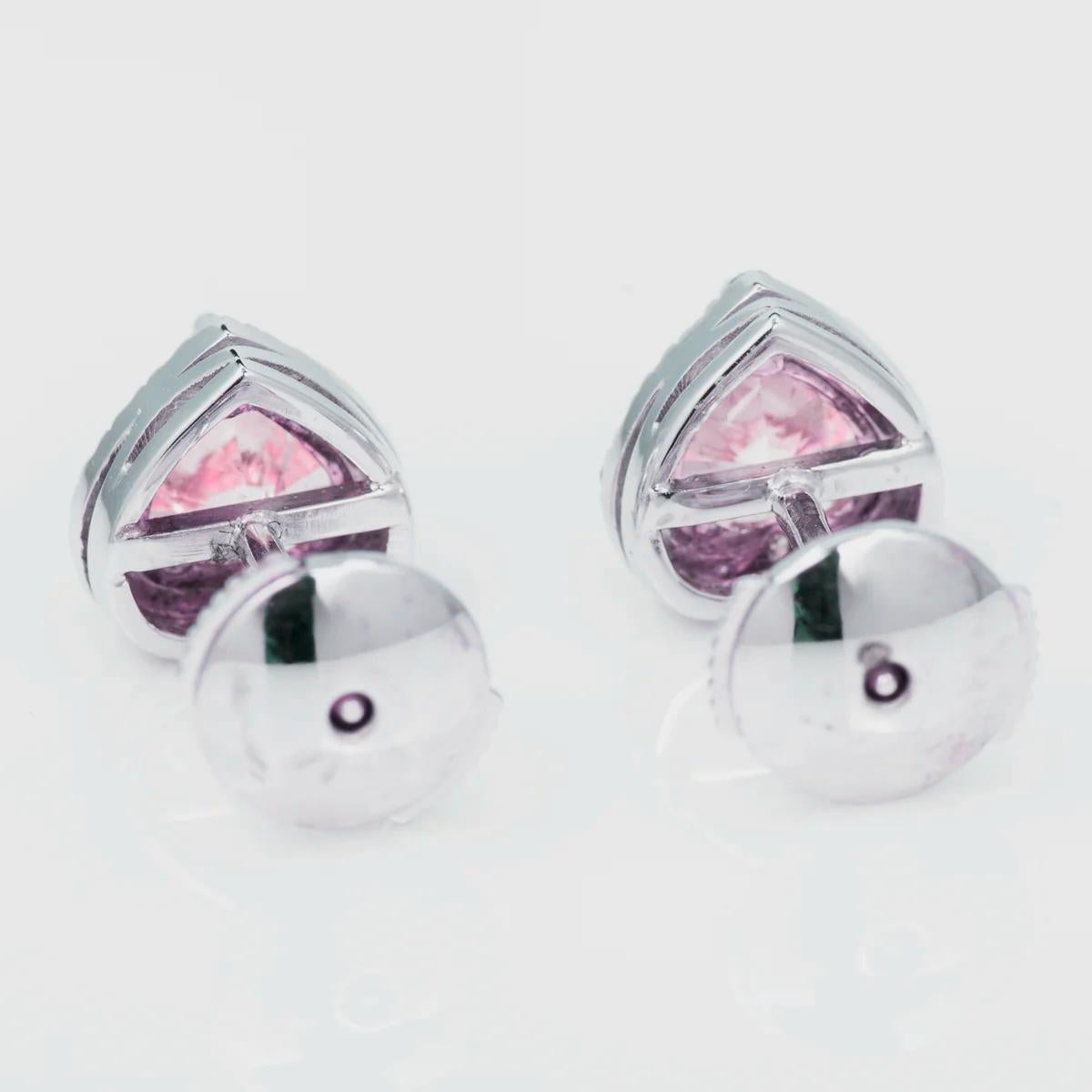 This pair of heart-shaped 18K white gold halo stud earrings are just gorgeous! The two GIA certified perfect match fancy light pink diamonds are surrounded by round brilliant cut diamonds d/e color vvs clarity which really make an