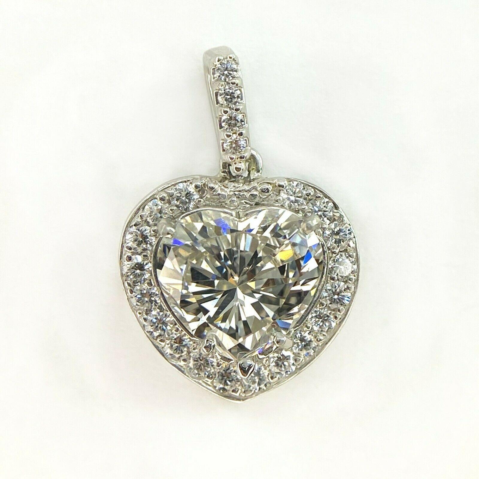 This beautiful pendant has heart cut diamond surrounded by a row of sparkling micropavé diamonds(approximately 0.30ctw, 22ps). Center stone is GIA 2.60ct J SI1 diamond heart cut. It is 22mm long, 14mm wide, 6mm thick.
Specifications:
    PENDANT