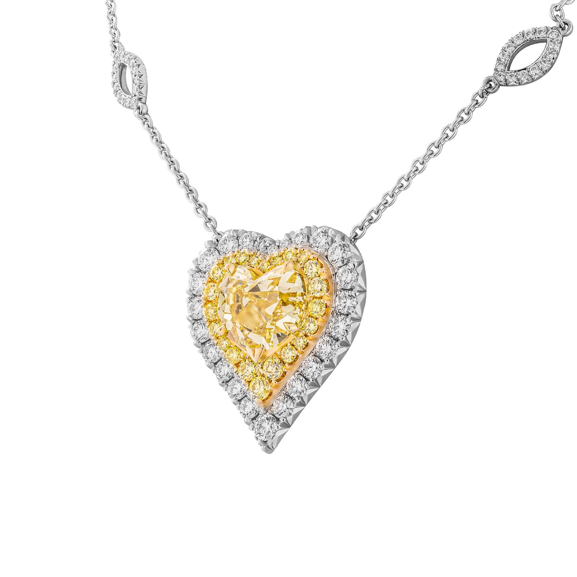 An absolute stunner!
Beautiful Heart Shape Fancy Intense Yellow Diamond Pendant with 2 rows of white & fancy yellow diamond halo around to highlight the beauty of the stone, totaling 0.73ct of fancy yellow diamonds and 2.73ct of full brilliant cut