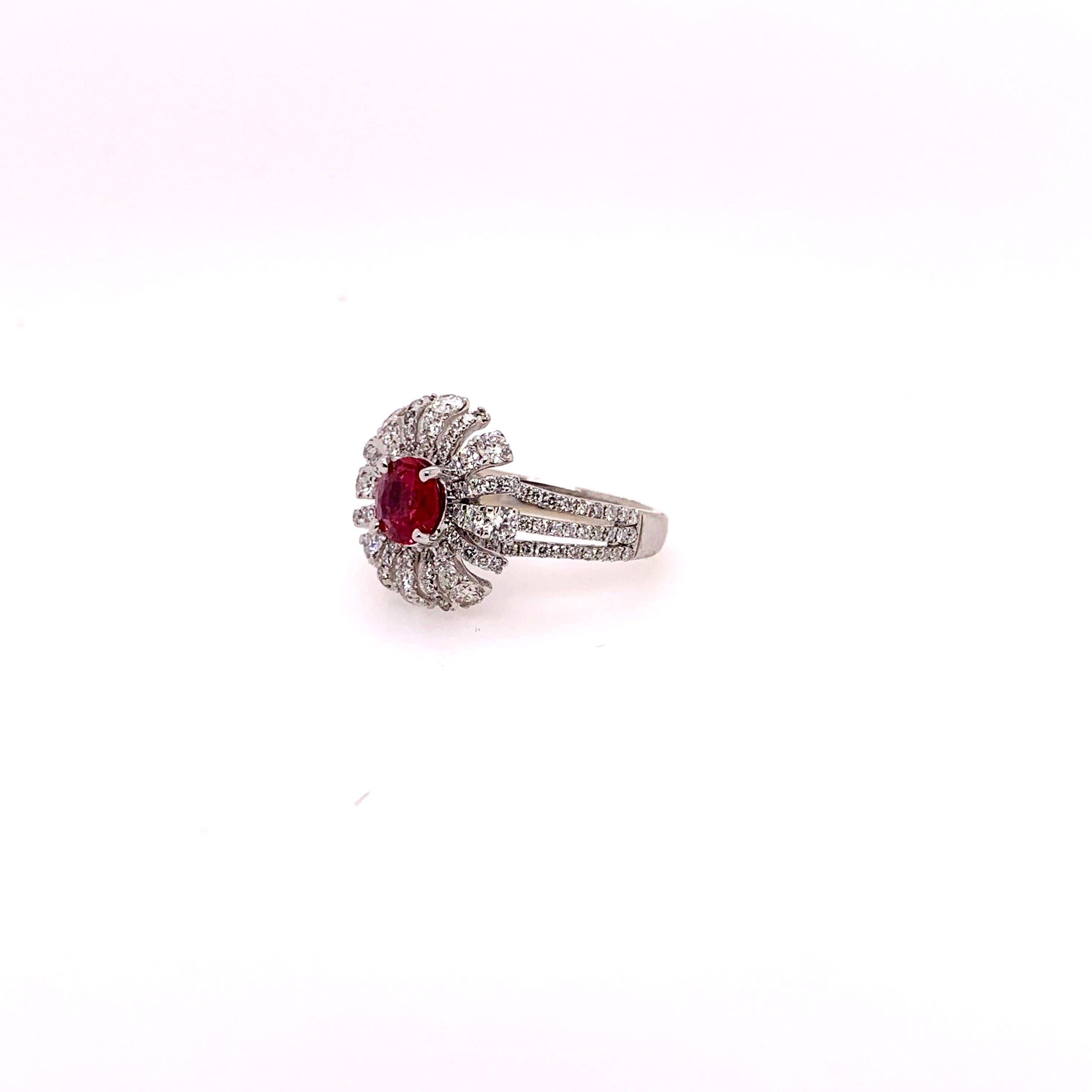 Stunning GIA certified ruby with a strong, red vivid color hue that is set within a custom made setting.  The 18k white gold setting is accented with 1.23 carats of round brilliant diamonds while the ruby weighs 0.95 carat.   The crisp, strong red