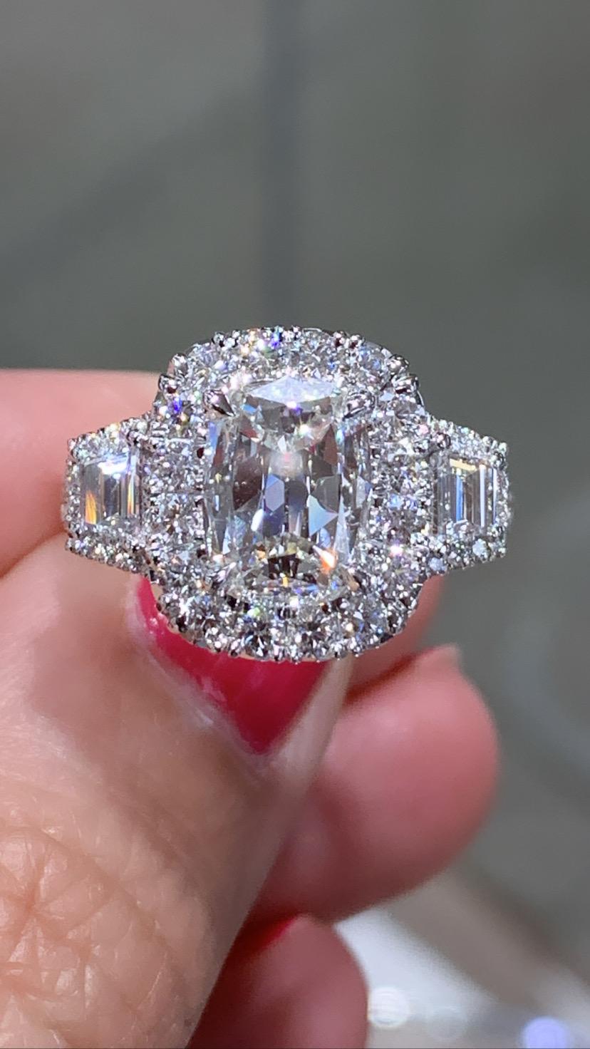 SKU: 126233
You will adore our cushion cut three stone fancy cushion center 1.55ct diamond, side 2 Trapezoid Diamonds 0.35ctw ring because of its fantastic sparkle and shine! Even more, the sparkle is added by pave set round diamonds around each 44