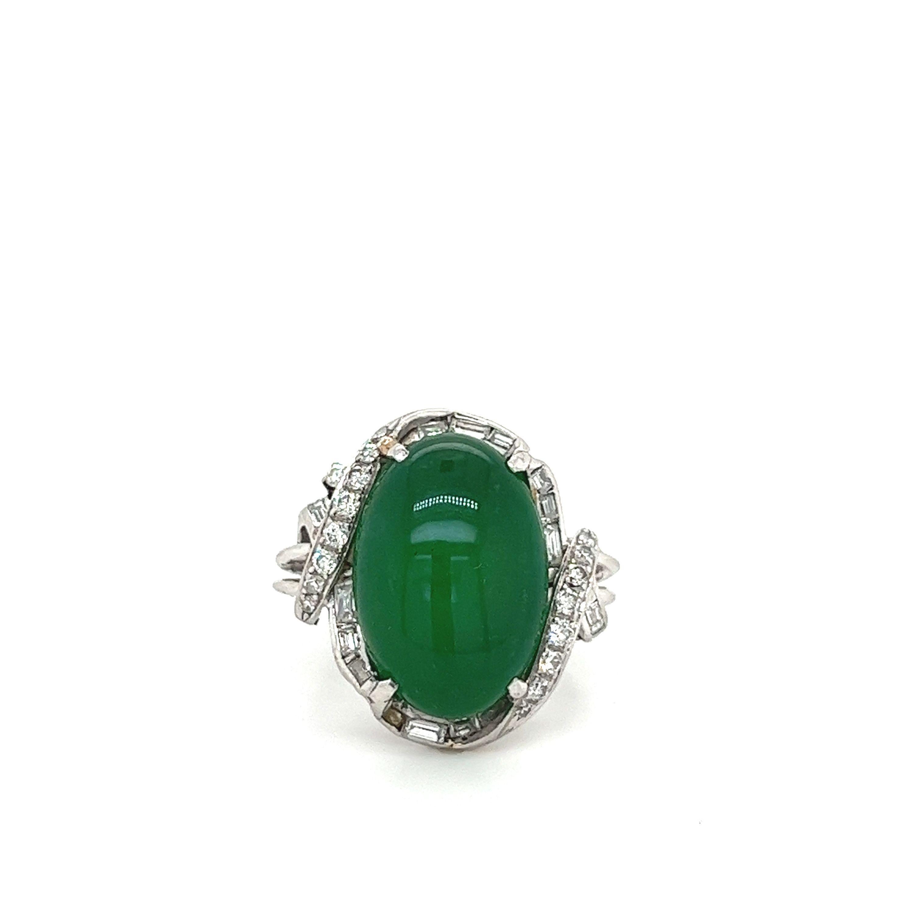 GIA-certified oval-shaped, cabochon cut Jadeite A Imperial Jade with 15 round cut and 10 baguette cut diamonds set in a vintage platinum ring. 

The Jade features an impressive and scarce natural green color with no color or clarity enhancements.