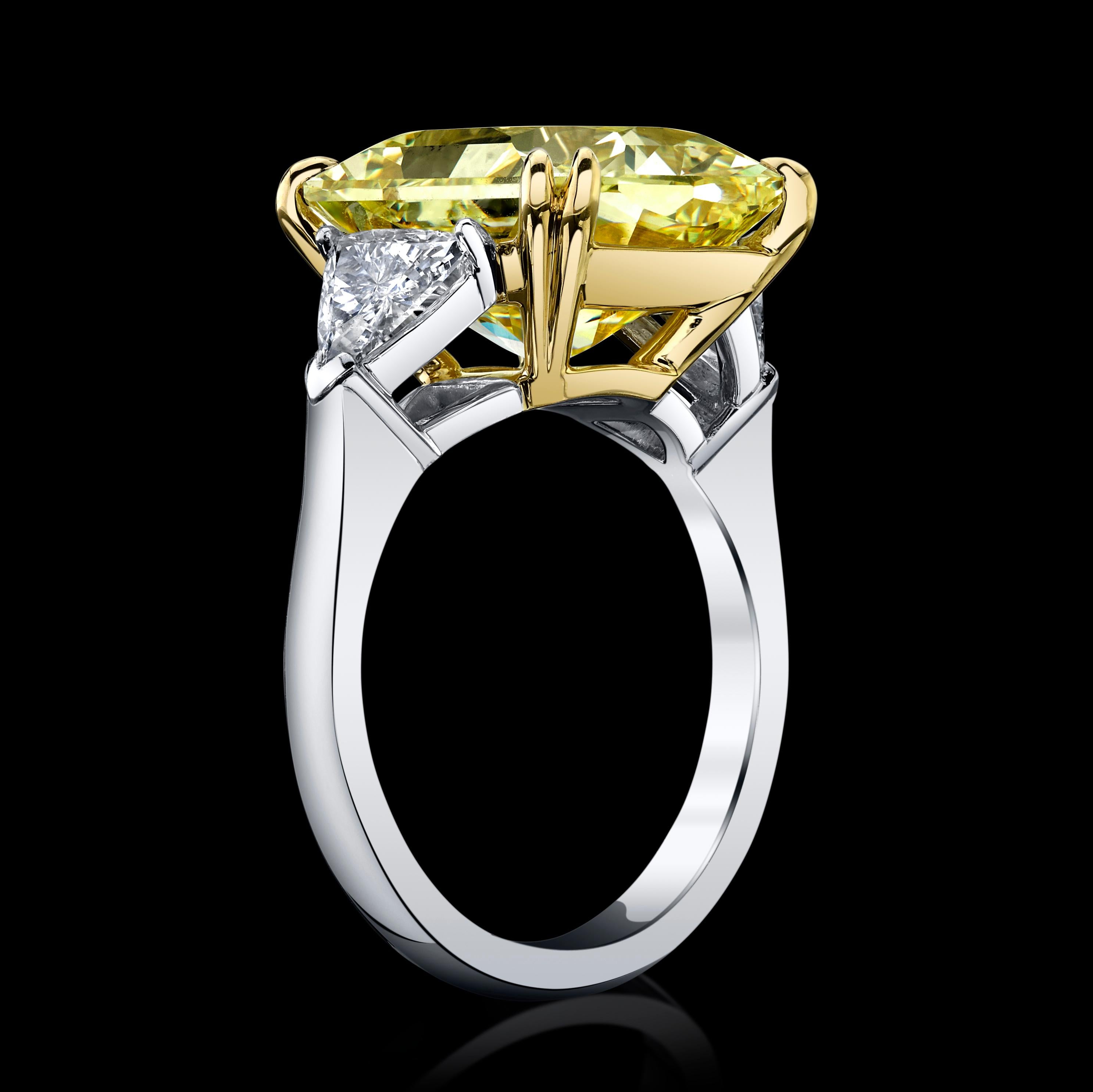 A strong color fancy intense large yellow diamond set in a classic platinum ring mounting with two trapezoids side diamonds. With a Fancy Intense and VVS2 grading, this is a high-end jewel to be cherished and enjoyed for years. The center stone is