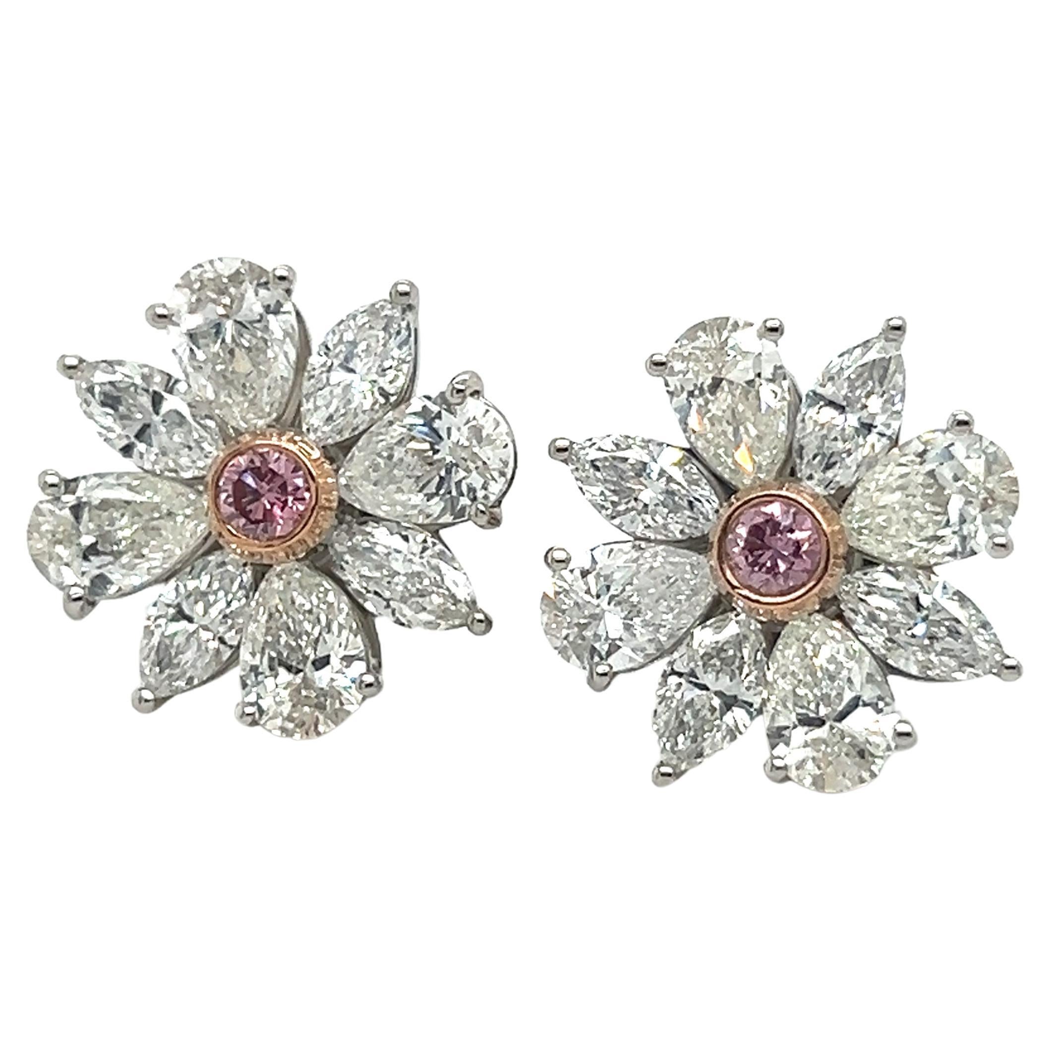 Hand crafted in house these gorgeous earrings highlight two GIA certified natural fancy intense pink diamonds. Each diamond weighs 0.09 carat and are the focal point of the pair. Hand crafted in platinum these earrings were hand built  for each