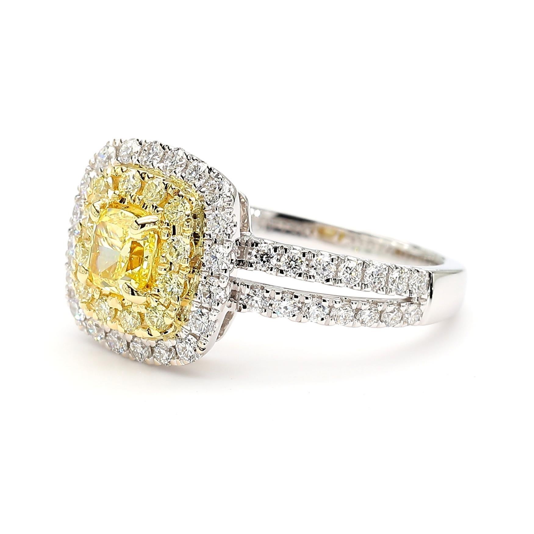 RareGemWorld's beautiful GIA certified diamond ring. Mounted in a beautiful 18K Yellow and White Gold setting with a natural cushion cut yellow diamond. The yellow diamond is surrounded by round natural yellow diamond melee and round natural white