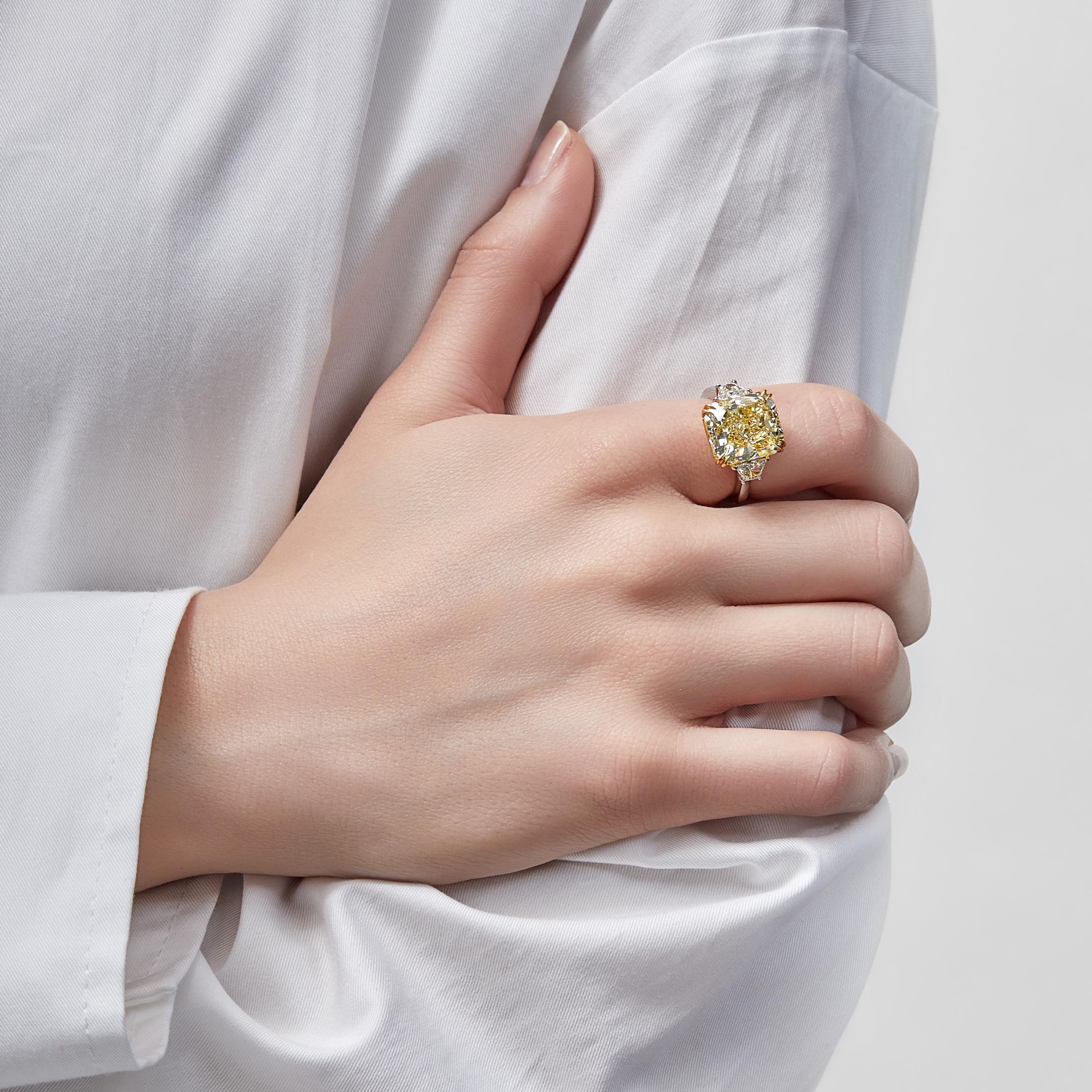 Elevate your style with our stunning Intense Yellow Radiant Diamond Ring. This exquisite piece features a mesmerizing yellow diamond in a cut-cornered rectangular cut.
The captivating Fancy Intense Yellow with an impressive weight of a total of 9.38