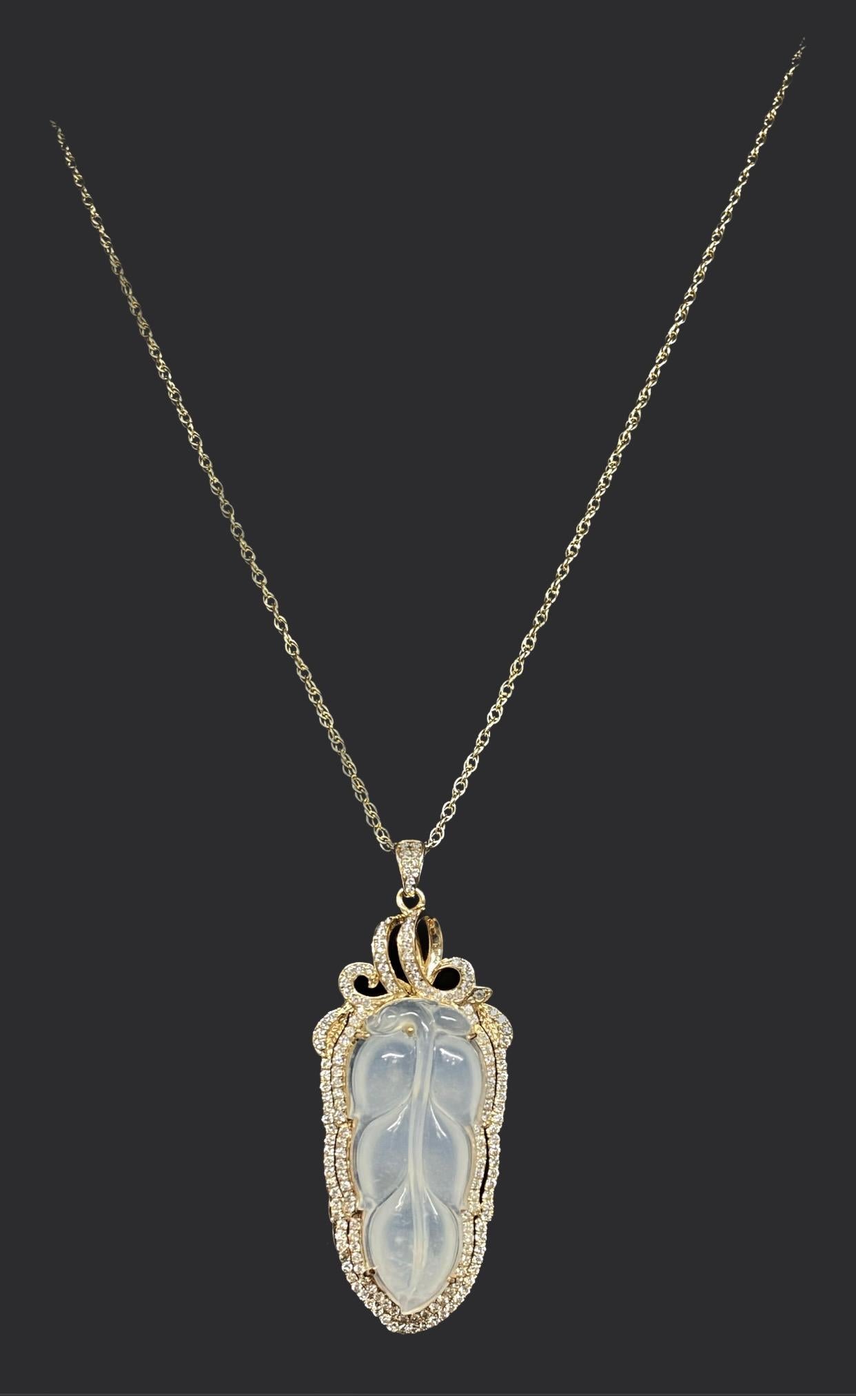 We are pleased to offer this superb and finely carved Icy Jade leaf pendant.  The glowing pendant has a double halo of sparkling round brilliant cut diamonds and set in 18k rose gold.  The luminous jade is transluscent and against the diamonds and