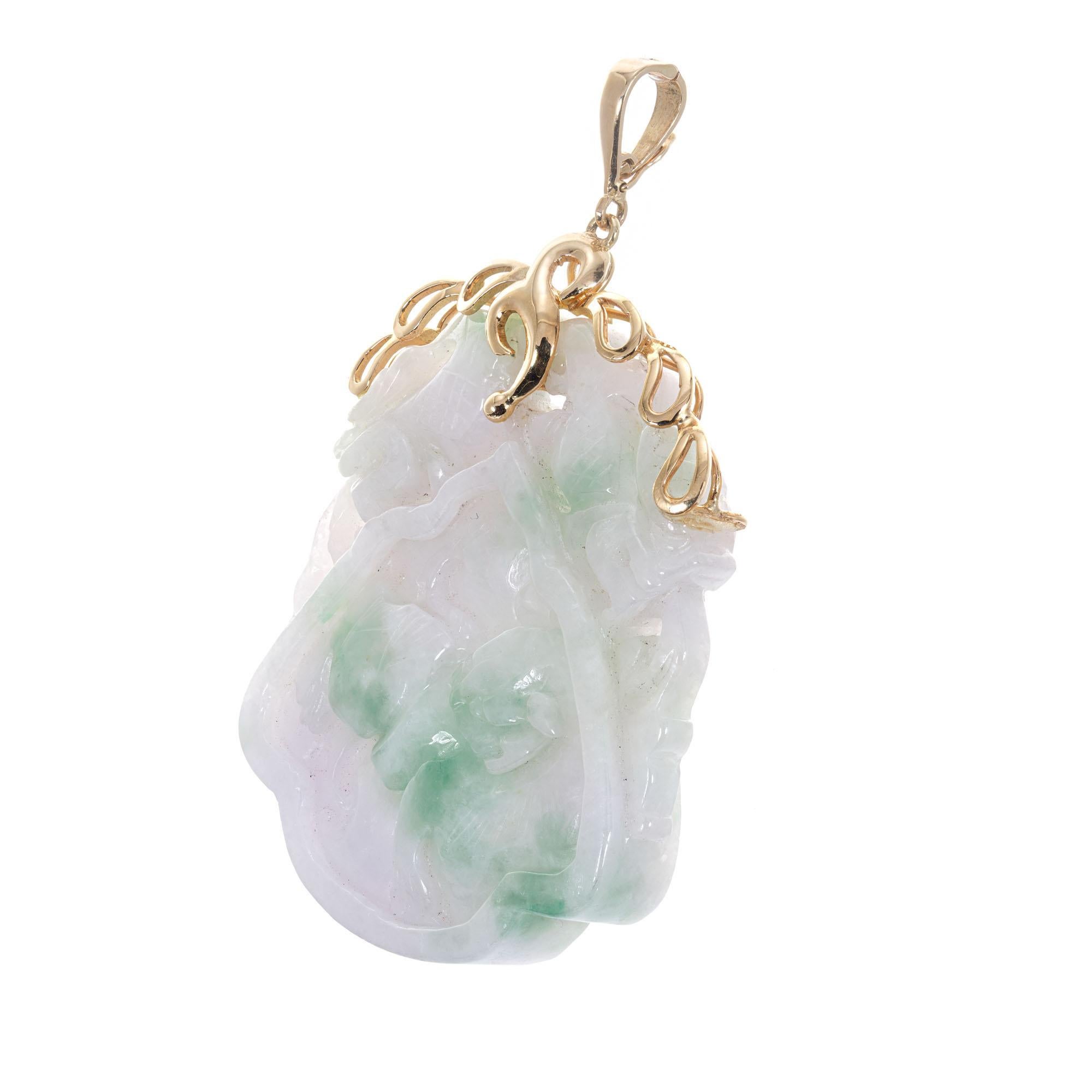 Vintage 1940-1950 intricate pierced and carved Jadeite Jade pendant. Custom designed 14k yellow gold pendant top. Later pendant enhancer bail. GIA certified natural and untreated Jadeite Jade. Carved on both sides.

1 carved & pierced variegated