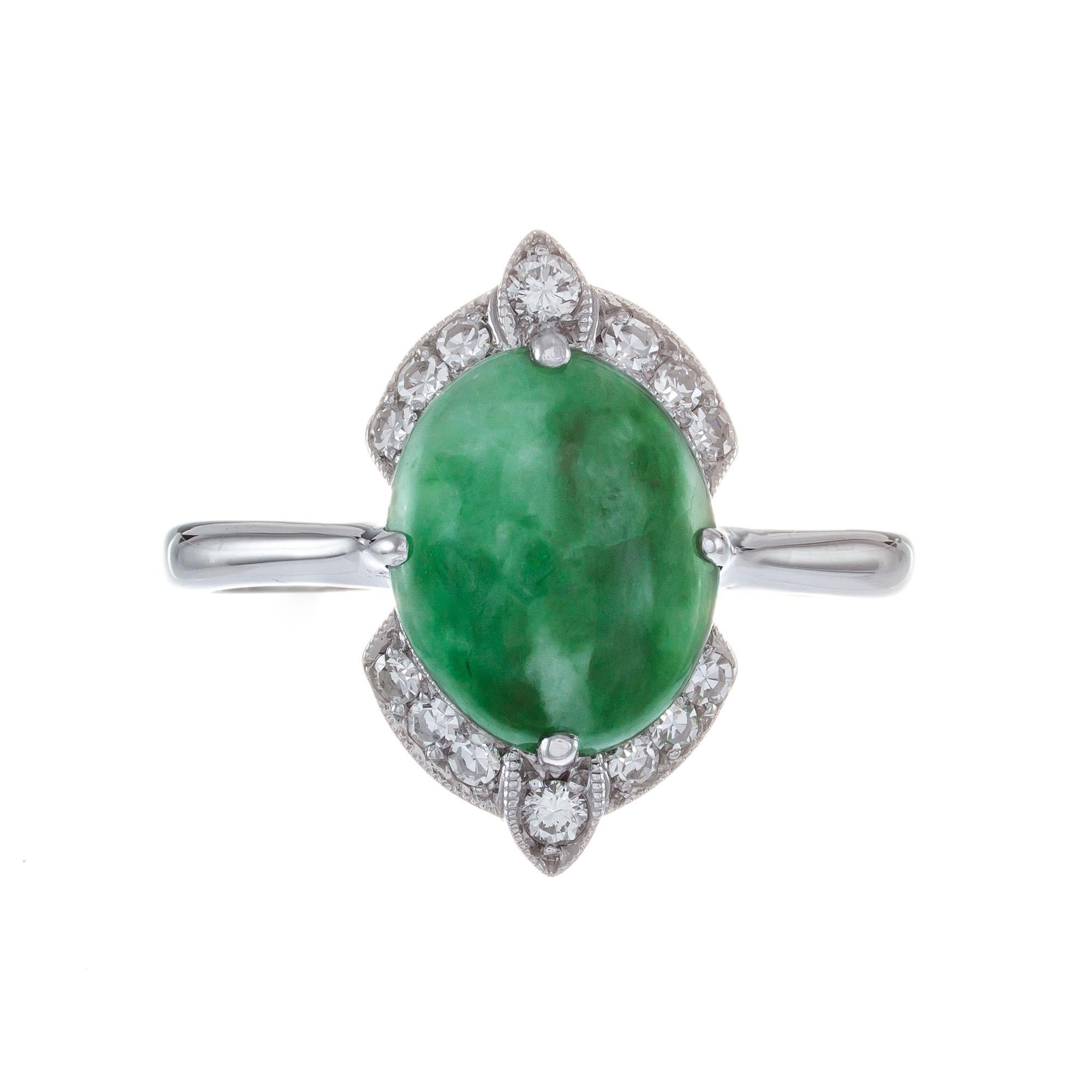 Vintage 1950's natural untreated GIA certified Jadeite Jade and diamond halo ring, set in 14k white gold setting.  

1 oval cabochon mottled green jade, GIA Certificate # 5202495317
2 round brilliant cut diamonds G VS, approx. .5ct
12 single cut