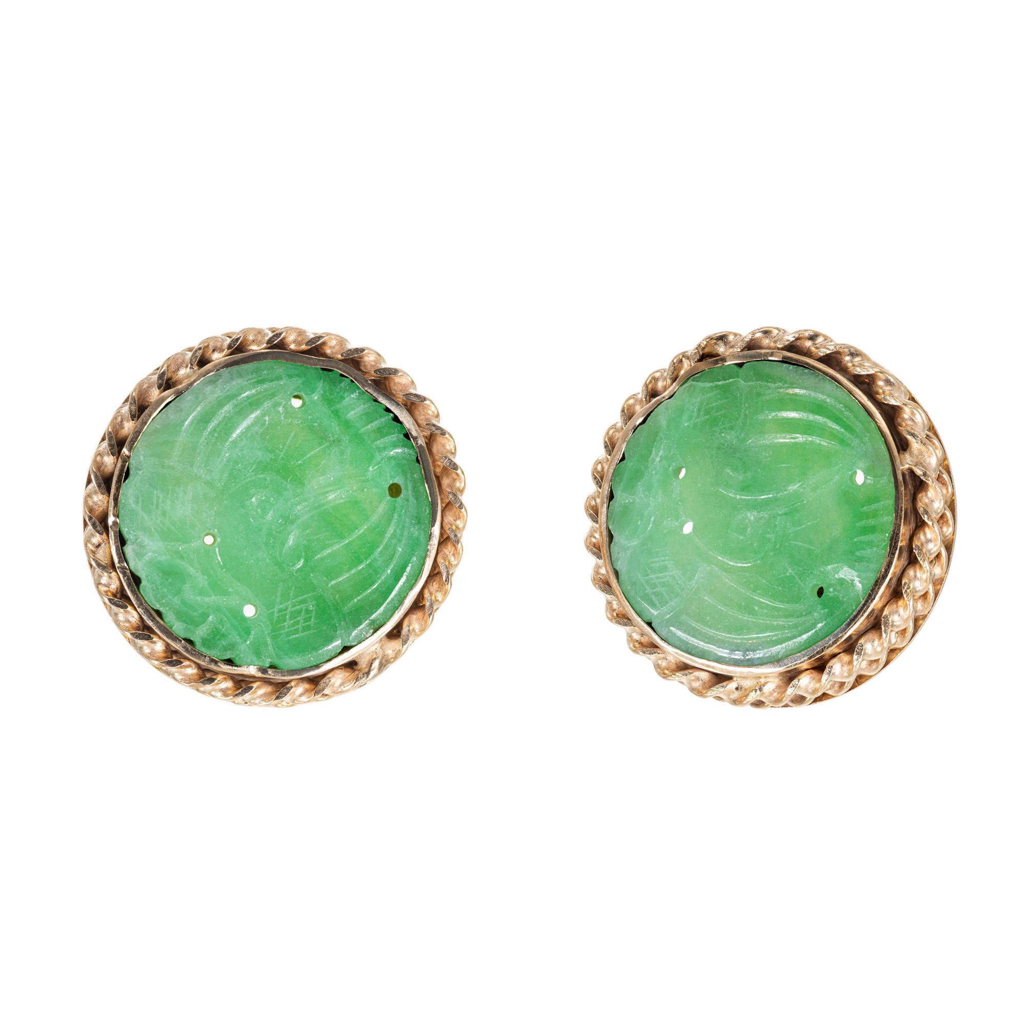 Handmade 1940’s Jadeite Jade Carved Round Gold Earrings. GIA certified natural no enhancement jade pieces with a double 14k yellow gold rope frame. Certified as natural.  

2 carved and pierced Jadeite Jade, 16.94 x 16.54 x 1.48mm, no enhancements,