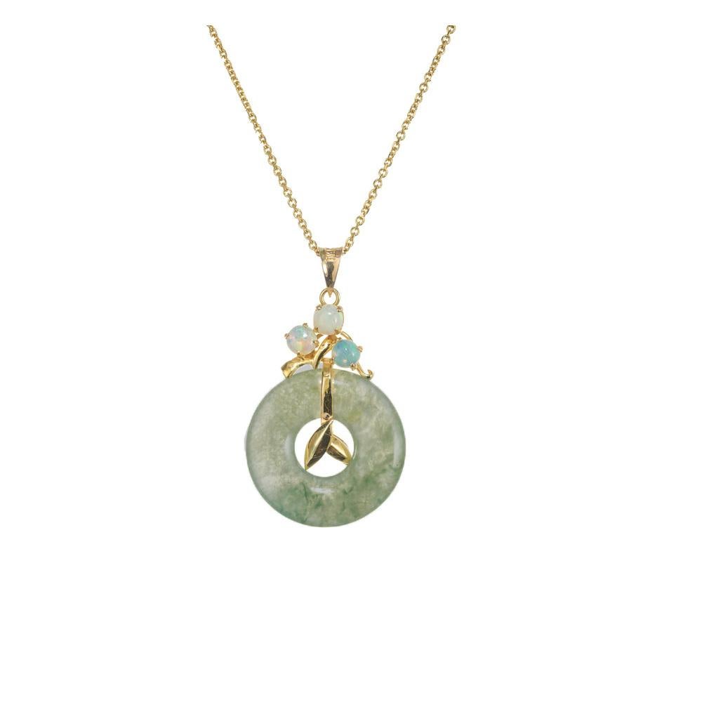 Opal and jade pendant necklace. GIA certified natural, no indications of impregnation jadeite jade open circle, in a 14k yellow gold setting, accented with 3 round cabochon opals. 14k yellow gold 16 inch chain.  

1 hololith mottled green jade (