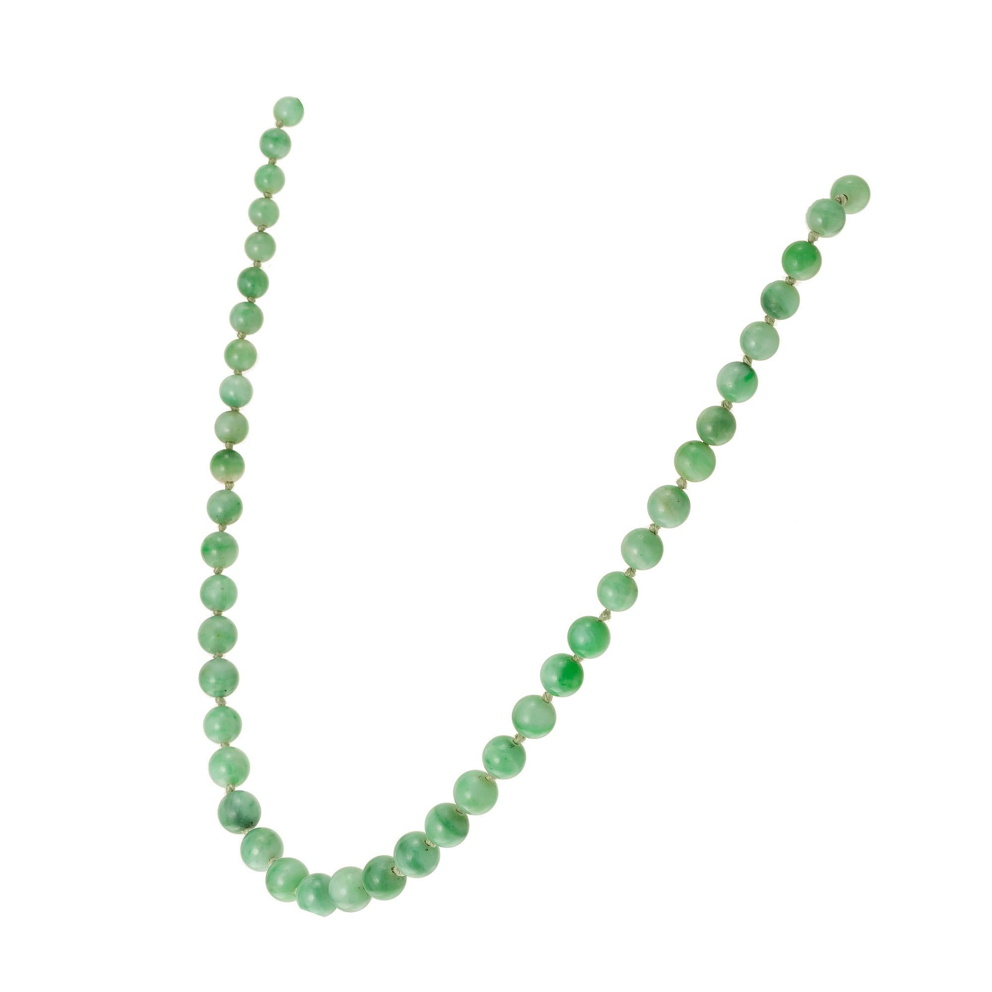 GIA Certified A grade natural untreated, well polished Jadeite Jade graduated necklace. circa 1900 with platinum top and 14k gold catch.  16 inches. 

62 mottled green jadeite jade, 3.8mm-6.8mm GIA certificate # 1226127161
Platinum
14k yellow gold