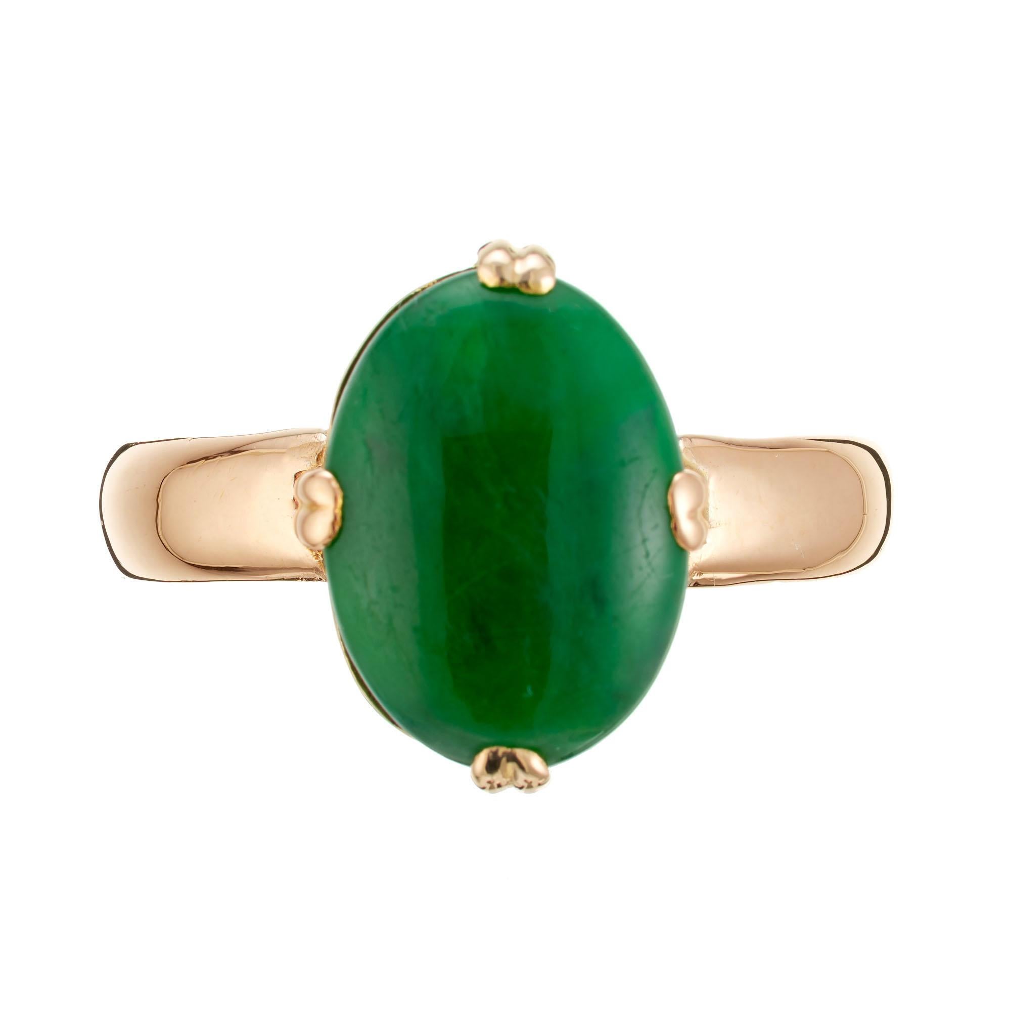 1950's GIA certified oval natural untreated jade stone set in 14k rose gold ring. 

1 oval cabochon green jadeite jade, GIA certificate # 5211798001
Size: 7.5 and sizable
14k rose gold 
Tested: 14k
4.0 grams 
Width at top: 13.5mm
Height at top: