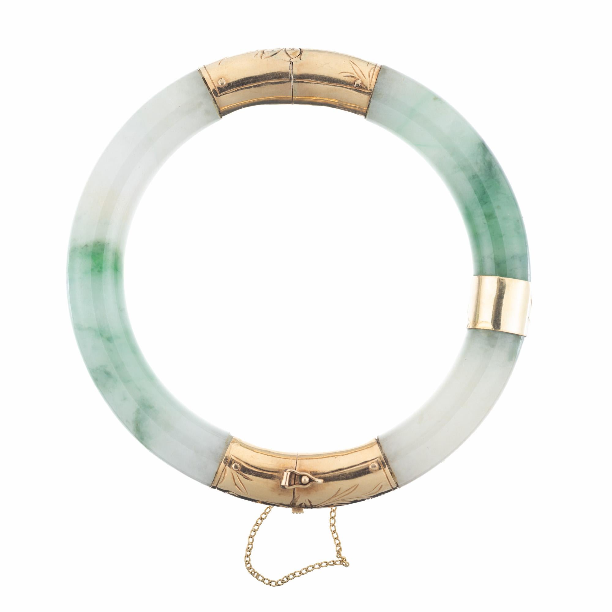 Vintage 1950's mid-century hinged jadeite jade bangle bracelet. GIA Certified Jadeite Jade Yellow Gold Bangle Bracelet. The GIA has certified the jade as natural, no indications of impregnation. The vibrant 14k yellow gold setting beautifully