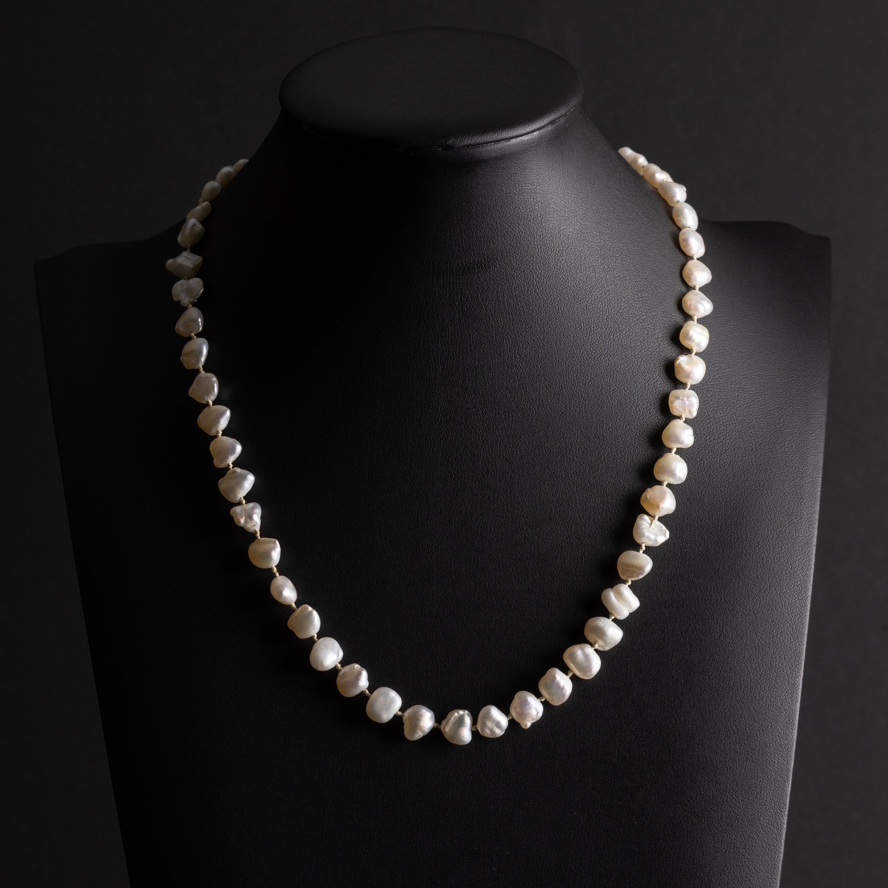 52 gorgeous, non-bead cultured freshwater pearls create a necklace that is both sophisticated and casual at the same time. The pearls all have a white body color but their overtone is varied: pink, soft blue, a hint of apricot. Because these pearls