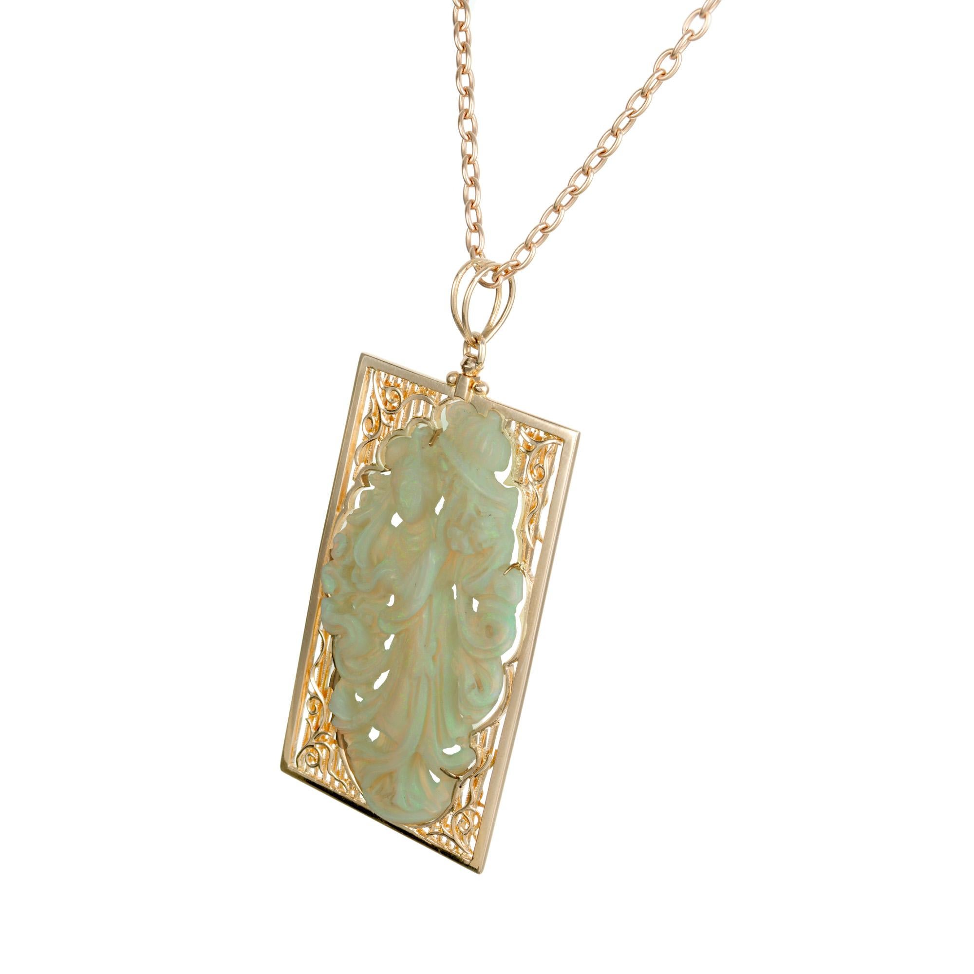 Hand carved opal pendant and necklace. Intricate blue green opal carvings of a woman in flowing robe framed in a 14k rose gold setting. The opal is carved from Coober Pedy Australian natural opal, mined from 1960-1970. 16 inch 14k rose gold chain.