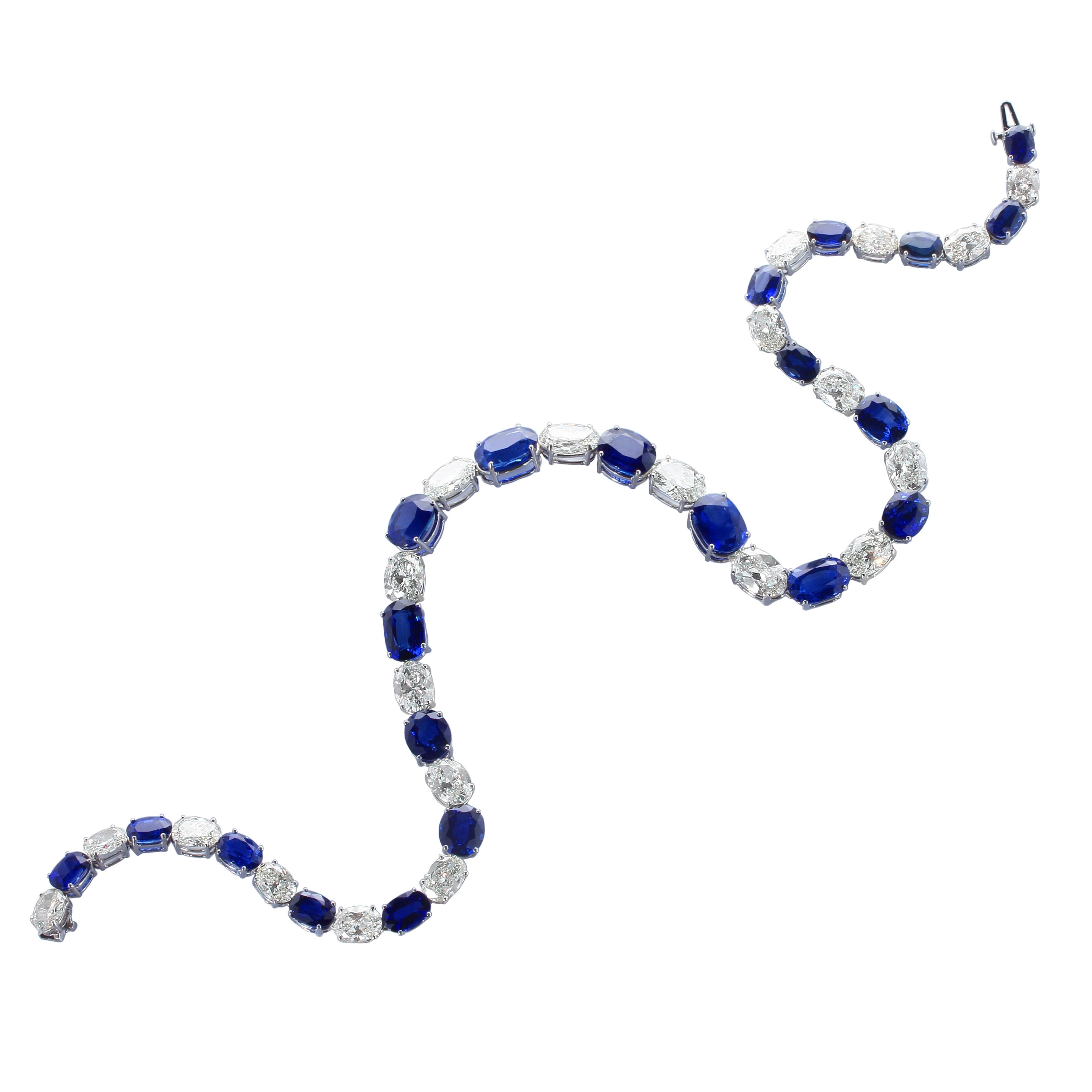 A highly impressive, brilliant, and well-crafted sapphire and diamond eternity necklace with twenty-one oval mixed-cut blue sapphires weighing a total of approximately eighty carats, alternating with twenty-one oval-shaped brilliant-cut diamonds