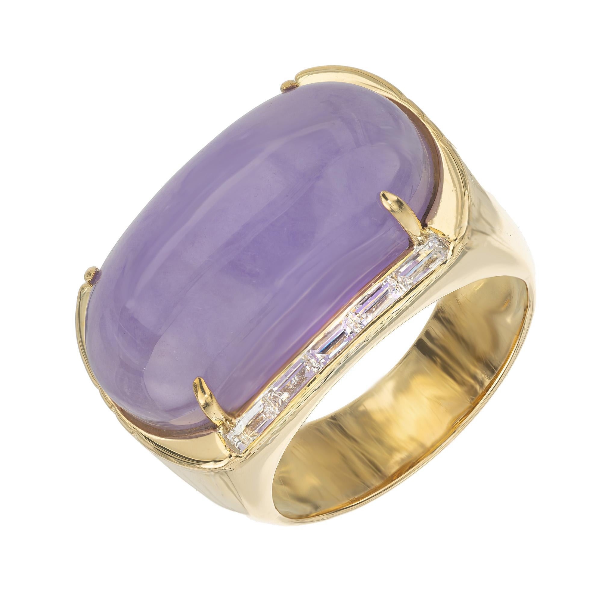 Natural untreated bright purple cabochon Jadeite Jade and diamond cocktail ring. Set with a large oval Jadeite that is mounted in an 18k yellow gold setting and accneted with 10 baguette diamonds. The Jade is certified by the GIA as natural, no