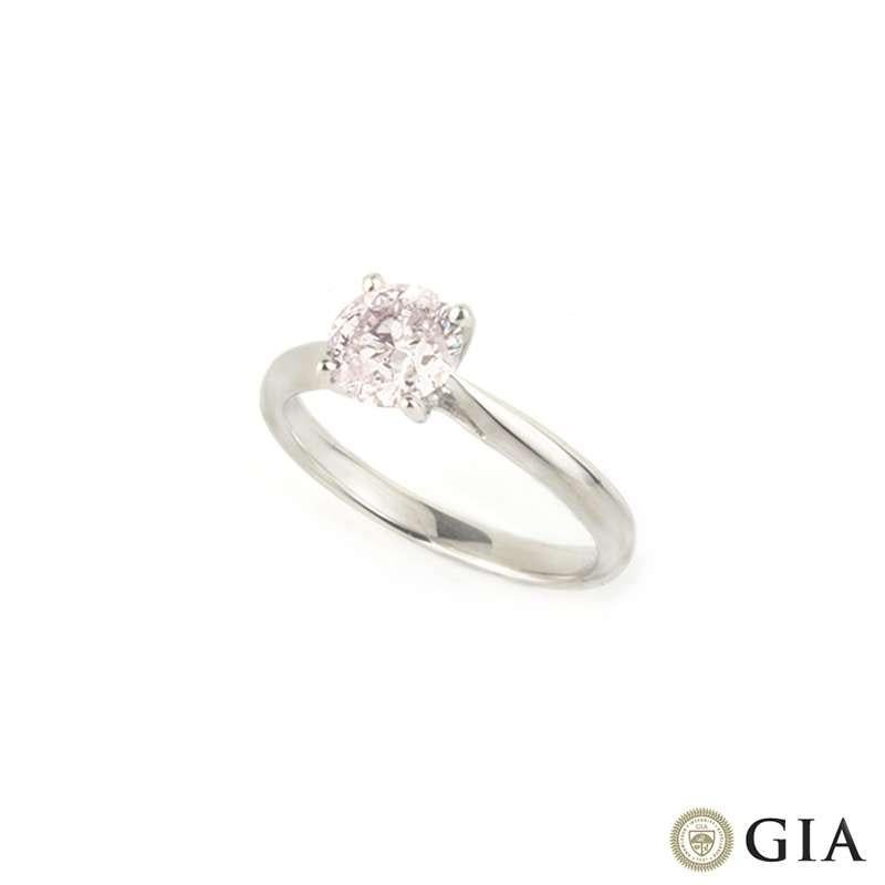 A unique light pink diamond ring set in 18k white gold. The light pink, round brilliant cut diamond weighs 1.09ct and is set within an elegant tapered four claw setting. This diamond is subtle yet exquisite. The ring is currently a size UK N - EU 53