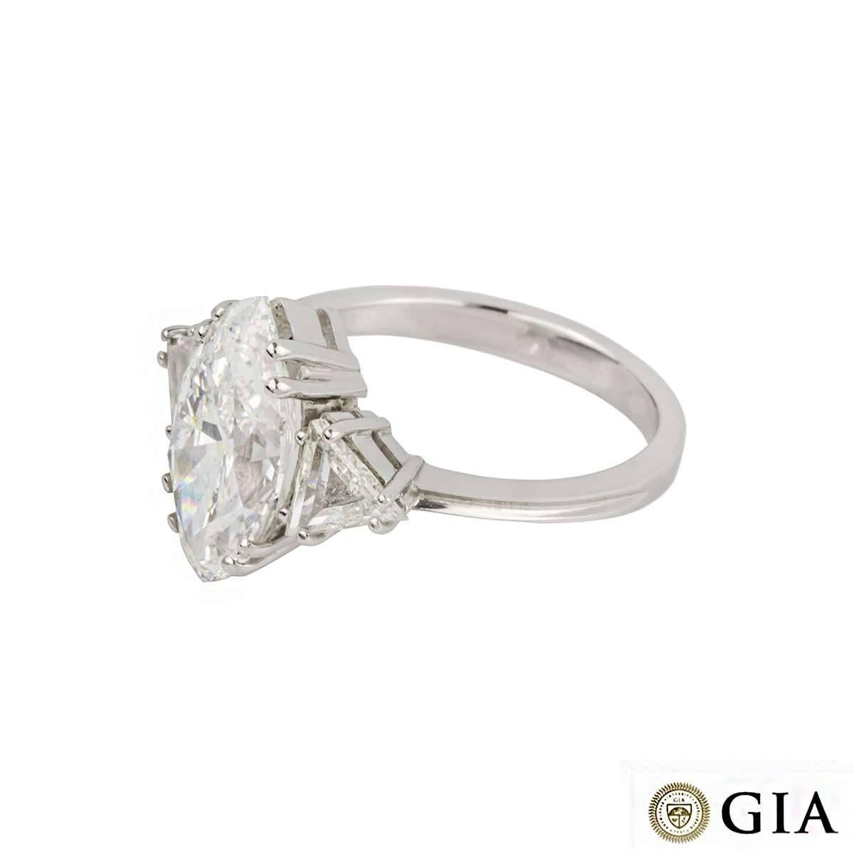 An magnificent diamond ring in 18k white gold. The central marquise cut diamond weighs 3.42ct, is D colour and VVS2 in clarity. The diamond is flanked by two triangular cut diamonds totalling approximately 0.80ct. The ring is currently a UK size N,