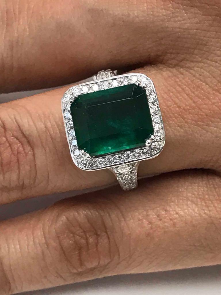 GIA Certified Minor Zambian Emerald cut Emerald 6.30 Carat encircled in halo of white diamond 1.75 carat flanked by white diamond pear shapes 0.25 Carat i a very elaborate and exquisite 14K White Gold Ring.

Style available in different price