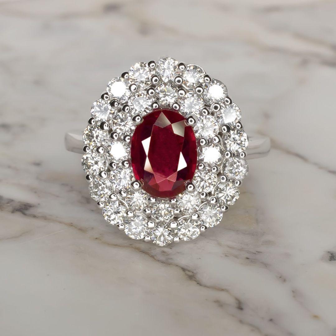 This spectacular oval ruby engagement ring features a magnificent,2.06 carat pure red ruby. This world class gem is a beautifully symmetrical oval with ideal color and exceptional brilliance and life. 

It is accompanied by Gemological Institute of