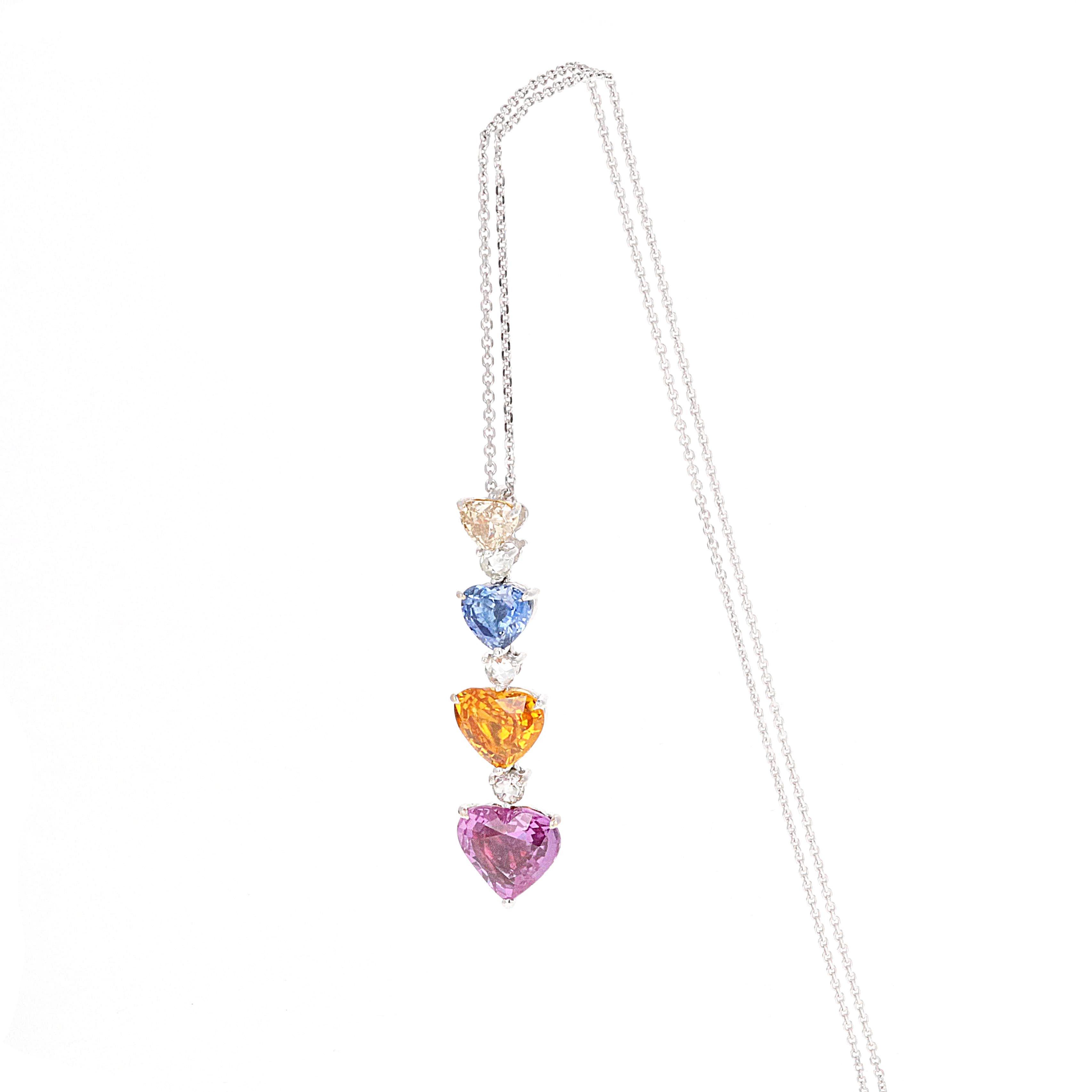 GIA Certified, 18 karat white gold diamond and multi color heart shape sapphire pendant drop necklace. The pendant is beautifully made with 4 different color diamond and sapphire hearts that are cascading down. Between each sapphire heart is a near