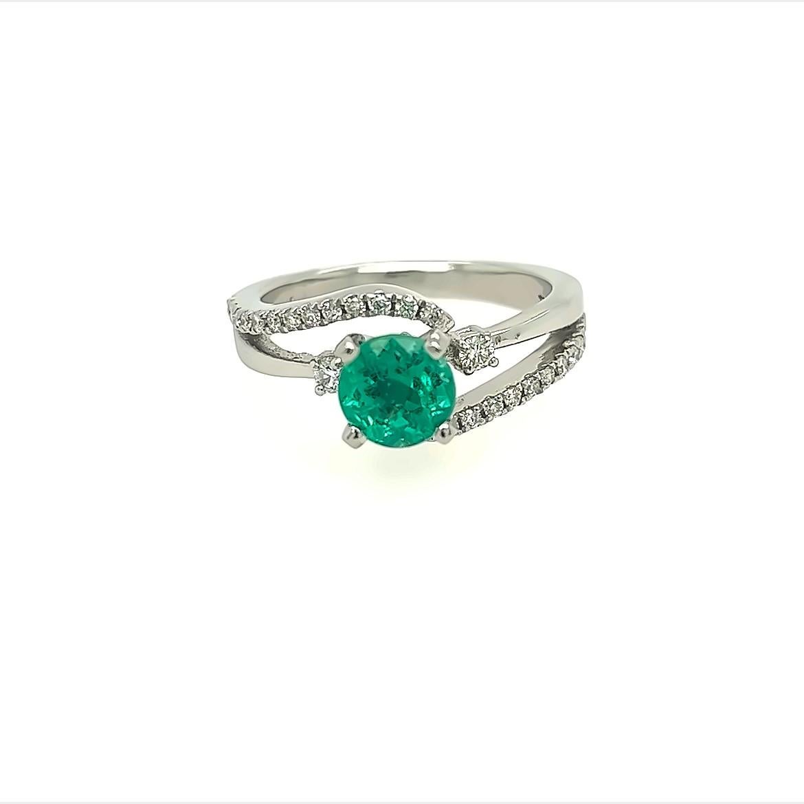 GIA Certified Muzo Mined  1.06 Carats AAAAA  Beautilful  Colombian Round  Emerald With the Color Of Vivid Green ,and a slight tint of Blueish Color, Famous from the Muzo Mine. Very Brightly  VS2 Diamonds surrounding This  Ring In 6.5 grams of .994
