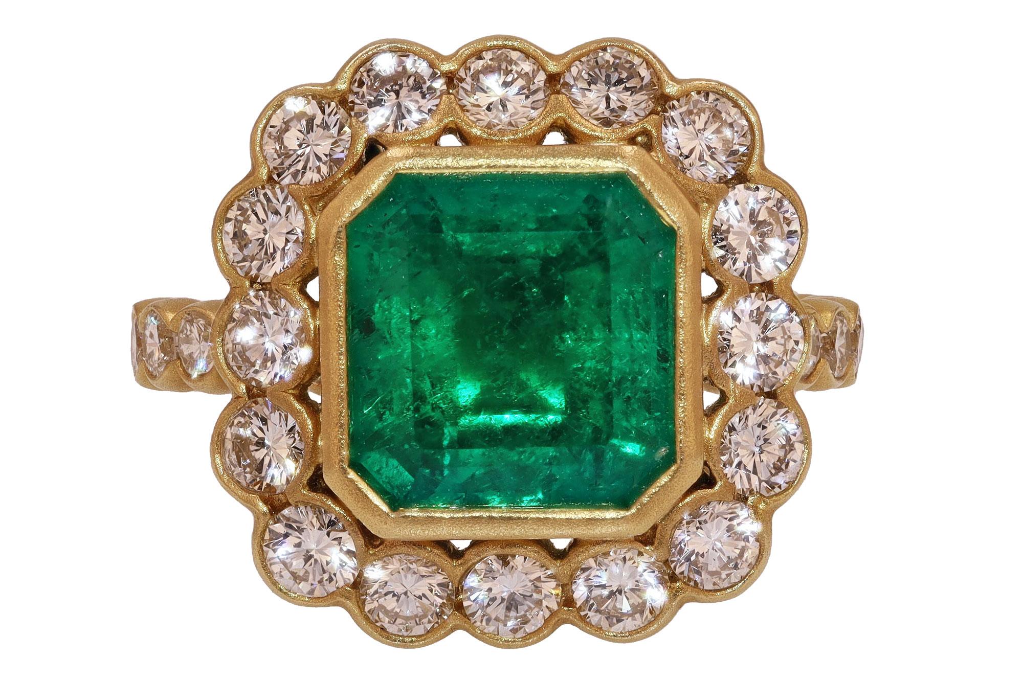 Hailing from the famous Muzo mine, we present this fine Colombian emerald and diamond halo engagement ring. Centered by an exceptional gem with a glowing, lustrous, intense green. The octagon cut weighs 2.75 carats set in a luxurious, buttery 18k