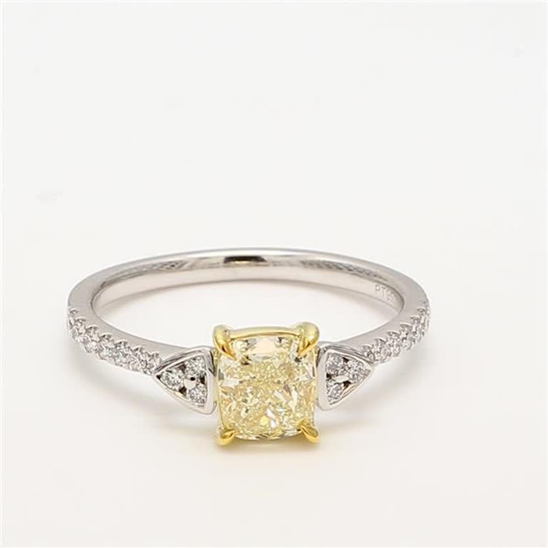 RareGemWorld's classic GIA certified diamond ring. Mounted in a beautiful 18K Yellow and White Gold and Platinum setting with a natural cushion cut yellow diamond. The yellow diamond is surrounded by round natural white diamond melee. This ring is