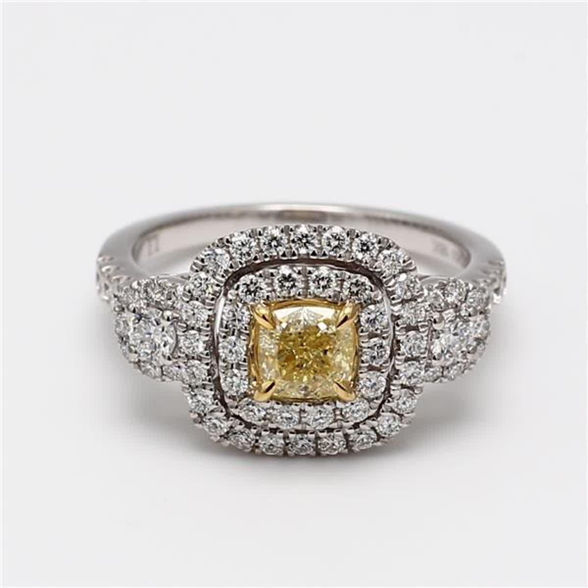 RareGemWorld's classic GIA certified diamond ring. Mounted in a beautiful 18K Yellow and White Gold and Platinum setting with a natural cushion cut yellow diamond. The yellow diamond is surrounded by small round natural white diamond melee. This
