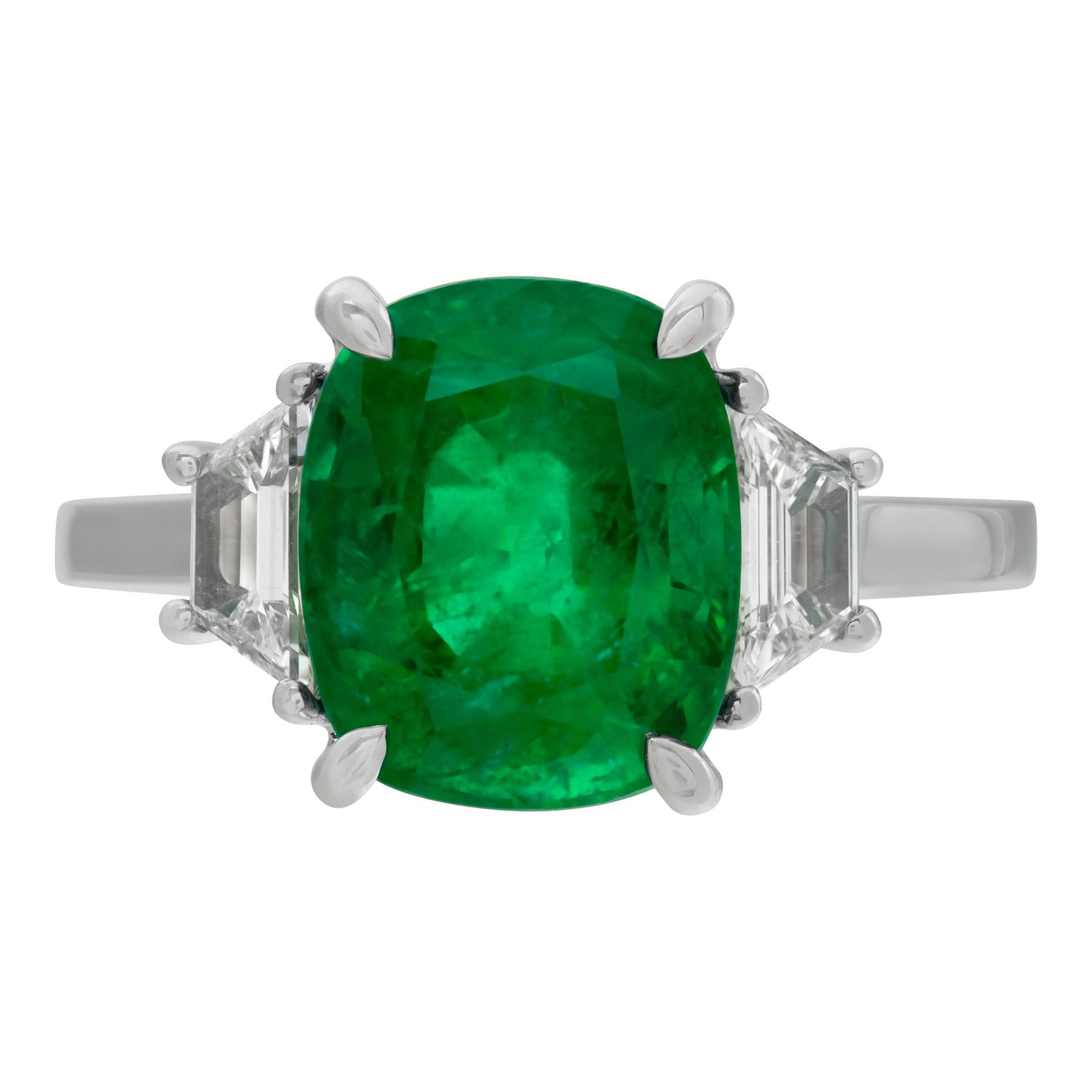 GIA certified 4.11 carat natural beryl cushion cut clarity enhanced emerald ring with 0.42 carat in trapezoid cut diamonds (G-H Color, VS Clarity) in 18k white gold setting. Size 6.5.

This GIA certified ring is currently size 6.5 and some items can