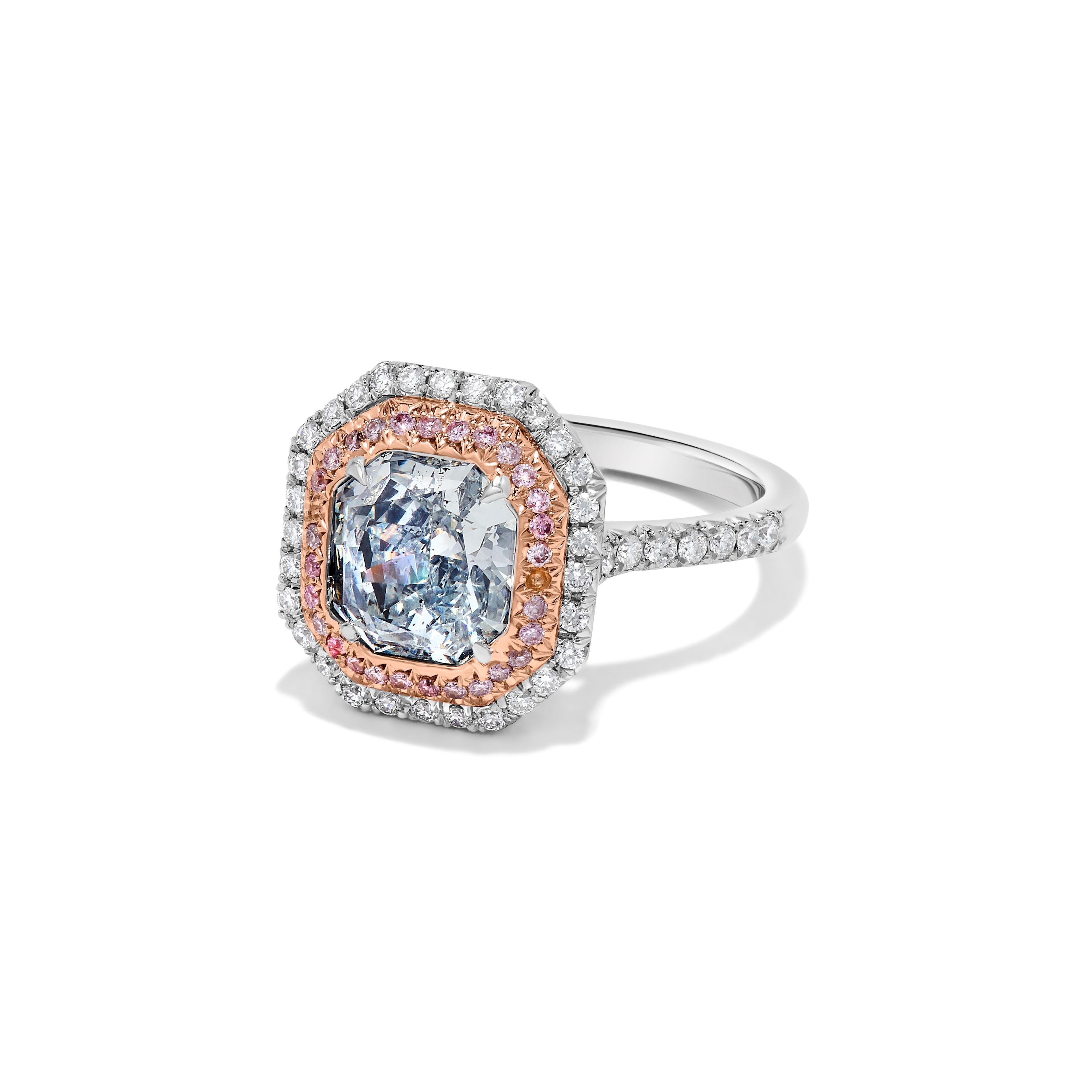 RareGemWorld's exquisite GIA certified diamond ring. Mounted in a beautiful 18K Gold and platinum setting with a natural radiant cut blue diamond. The blue diamond is surrounded by round natural pink diamond melee and round natural white diamond