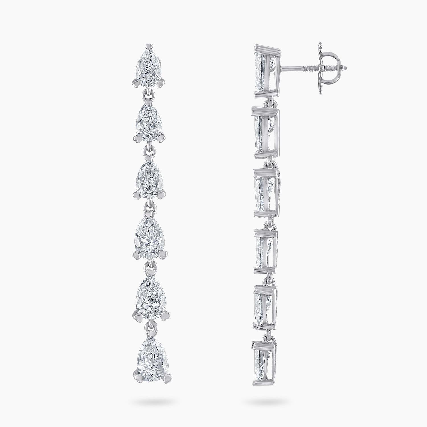 These exquisite 18k white gold dangle earrings are a dazzling display of luxury and refinement, featuring a total of 7.2 carats of natural brilliant pear-shaped diamonds. Each earring is adorned with six GIA certified pear-shaped diamonds, totaling