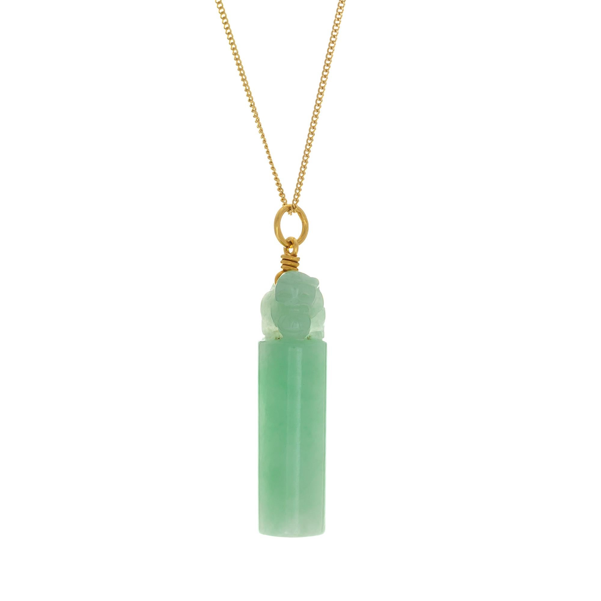 Mottled green natural jadeite jade tubular pendant with a carved dog at the top suspended from an 18 Inch 14k yellow gold chain

1 pierced tubular carved mottled green jadeite jade GIA Certificate #6203372876
14k yellow gold
Stamped: 750
Top to