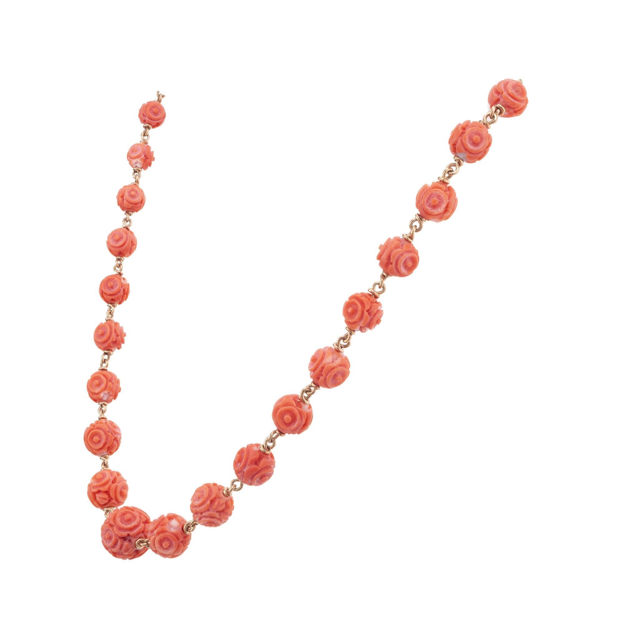 Stunning 1950's hand carved orange Coral bead necklace. 30 GIA certified round graduated carved coral, linked together by 14k yellow gold loops. The coral is highly detailed and beautifully carved. GIA certified as no indication of dye.  16 inches