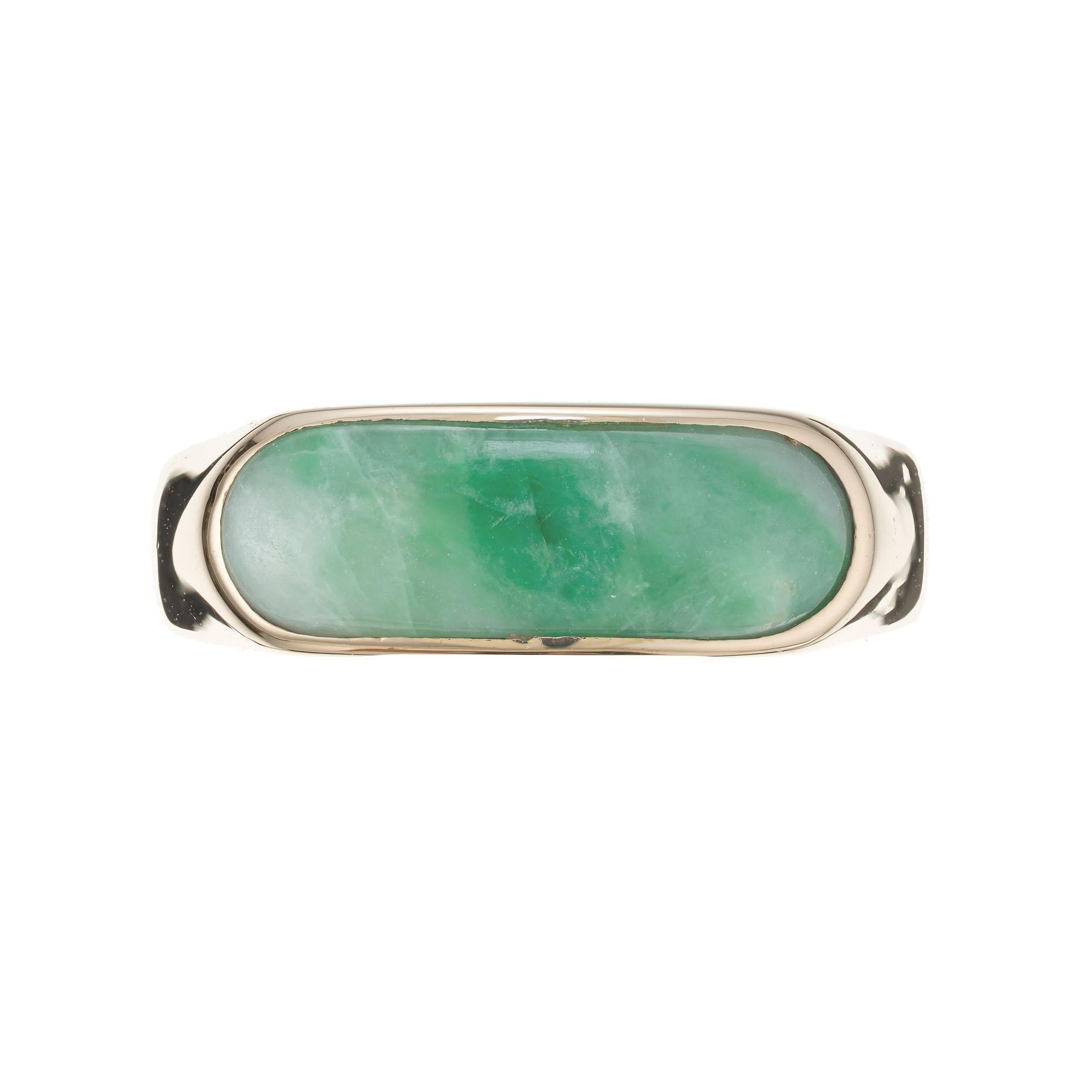 1960's Elongated jadeite jade saddle 18k yellow gold ring. GIA certified untreated bright green Jade. 

18k yellow gold
One mottled green natural untreated Jadeite Jade 14.9 x 5mm, semi translucent, natural, no treatment, GIA certificate