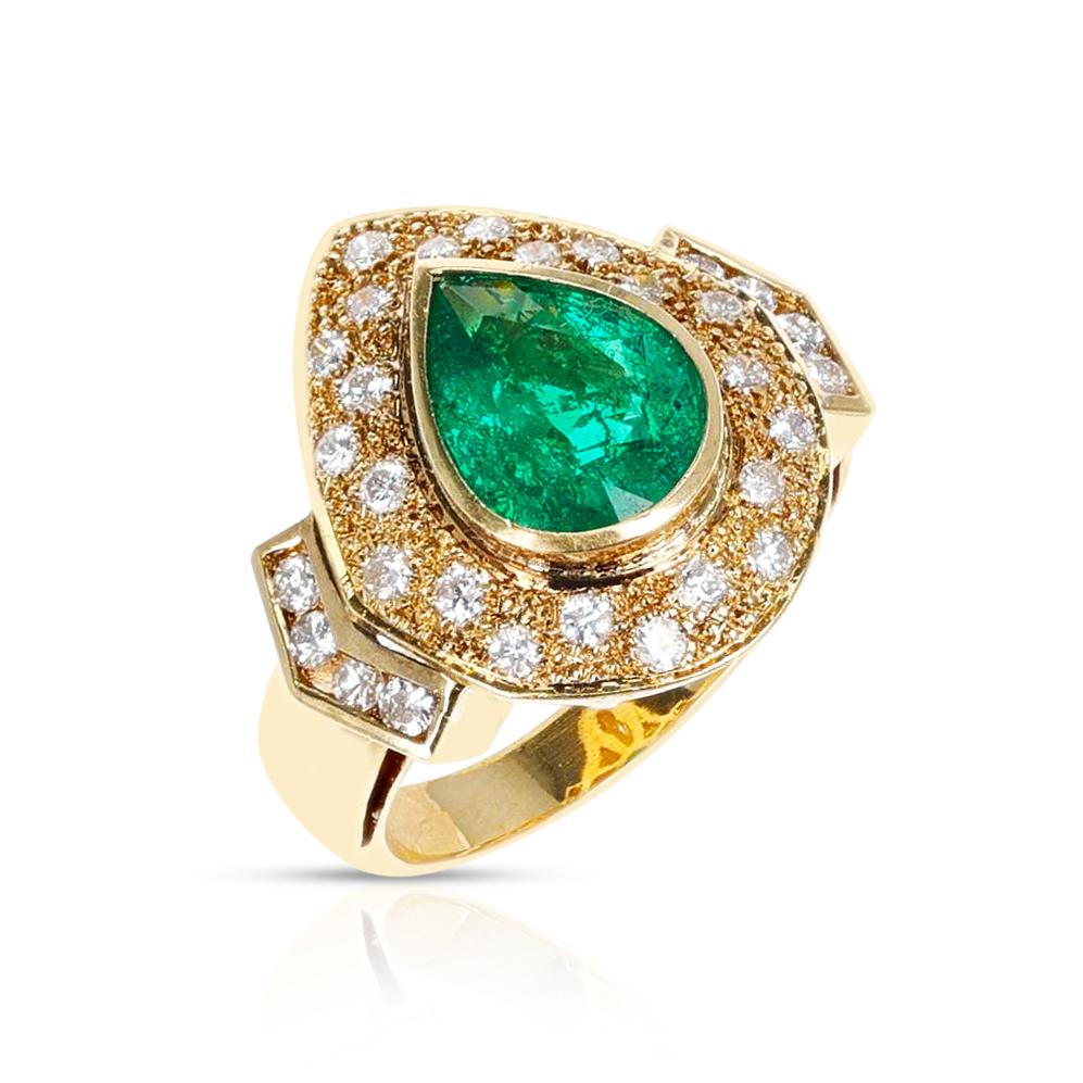 A bold and beautiful Pear Shape Emerald Cocktail Ring with Diamonds made in 18 karat Yellow Gold. The Ring Size is US 6.50. The total weight of the ring is 8.90. The GIA Certificate states that the Emerald is Natural and from Colombia. 