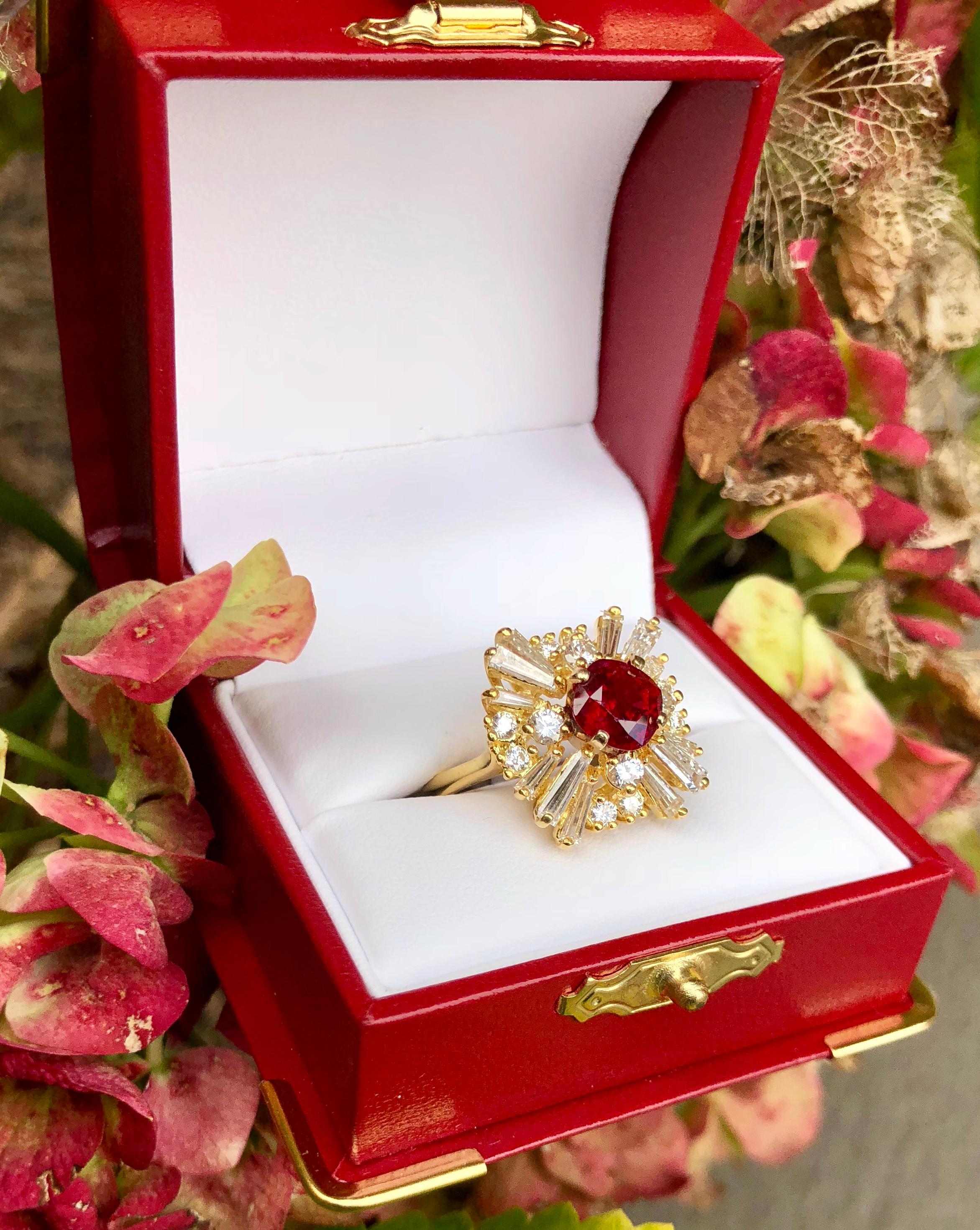 Beautiful brilliant cushion cut natural corundum ruby is GIA certified, prong set in 18 karat yellow gold and surrounded by prong-set tapered baguette and round diamonds in a timeless ballerina-style cocktail ring. The total combined carat weight of