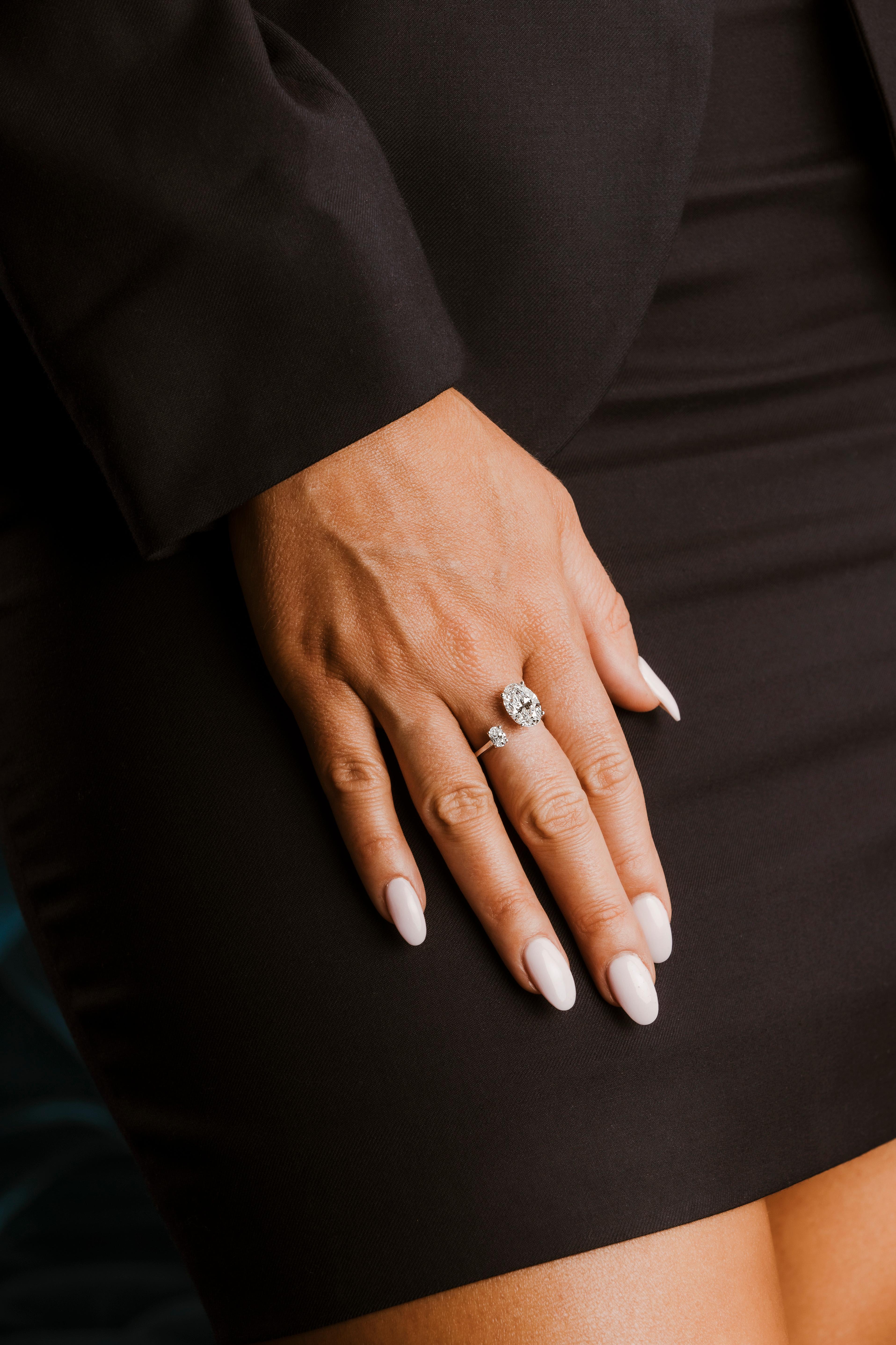 Discover the epitome of luxury with the 18k White Gold GIA Certified 3.62ctw Natural D Flawless Oval Brilliant Two Stone Ring. Featuring a 3.32ct D Color, Flawless Clarity main stone, and a 0.30ct secondary stone, both GIA-certified, this ring