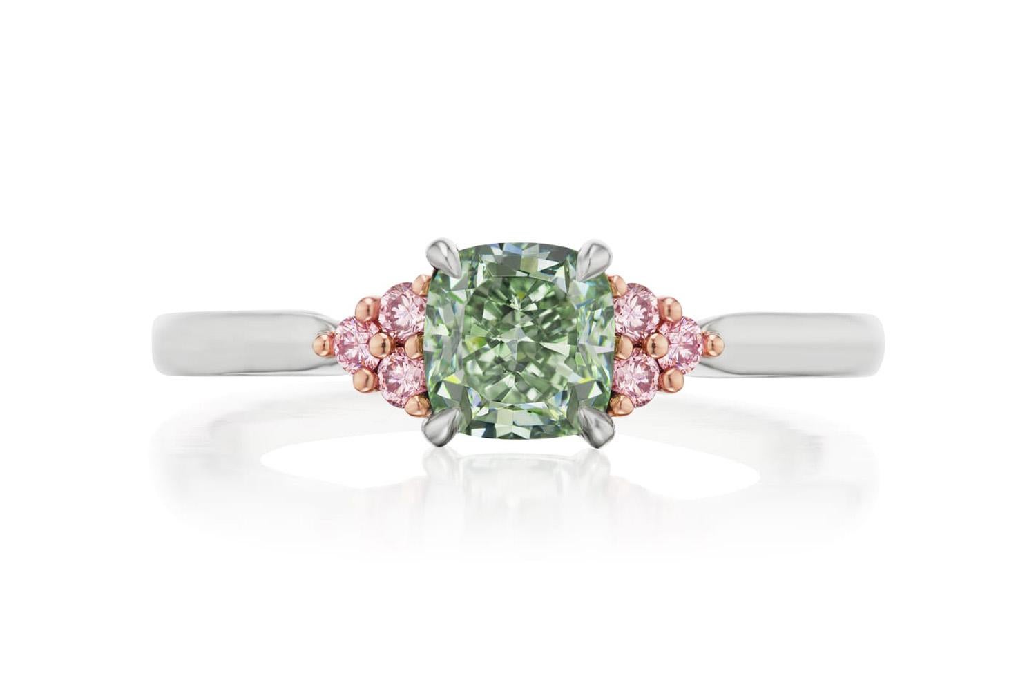 We are pleased to offer this Rare GIA Certified Natural Fancy Green & Pink Diamond Ring. This stunning ring features a GIA certified 0.80ctw natural fancy grayish green cushion cut diamond accented by 0.10ctw natural pink round brilliant cut