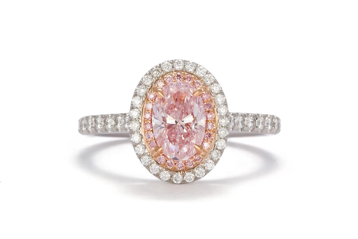 We are pleased to present this brand new 1.58ctw fancy pink oval diamond halo ring. This beautiful piece was custom designed in house and crafted from the finest materials. It features a GIA certified and laser inscribed 1.11ct natural fancy pink