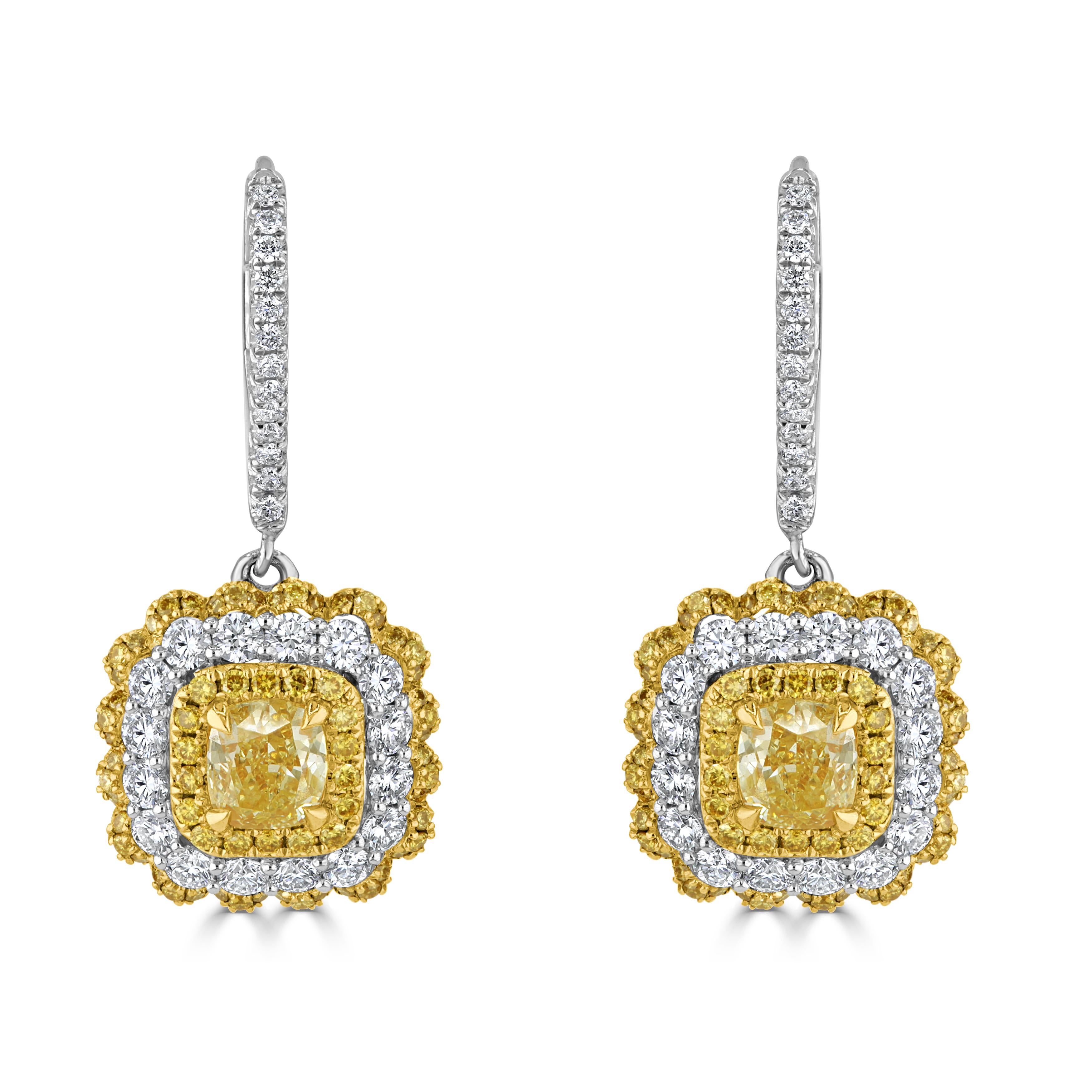 At the heart of these enchanting earrings are GIA-certified cushion-cut diamonds, captivating in their brilliance and clarity. These mesmerizing centerpieces are gracefully encircled by halos adorned with a delightful combination of round white and