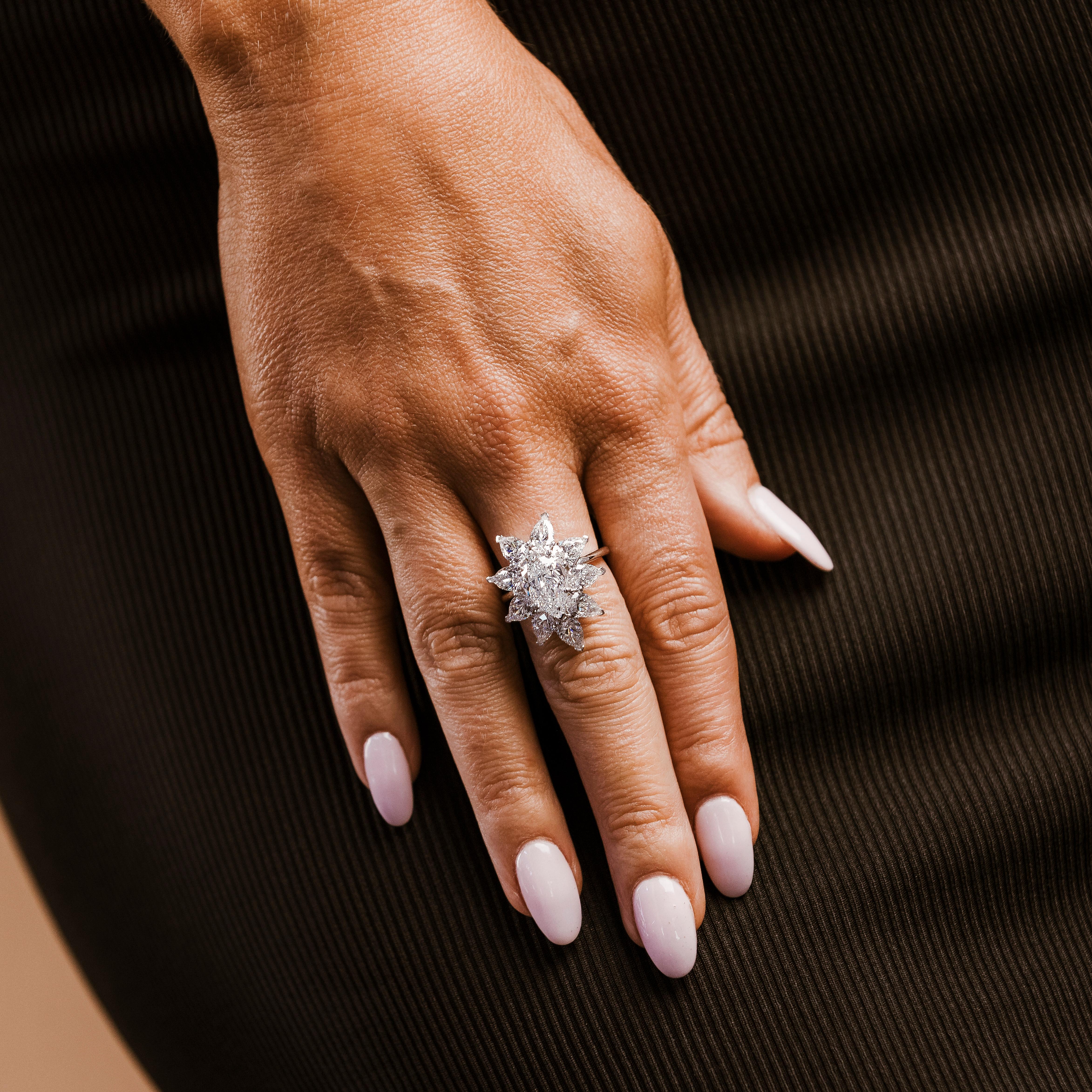 This stunning 18k white gold flower-shaped ring features a total of 7.66 carats of GIA certified natural brilliant pear diamonds. The centerpiece is a 3.01-carat diamond with D color and Flawless clarity (GIA# 2225526629), ensuring exceptional