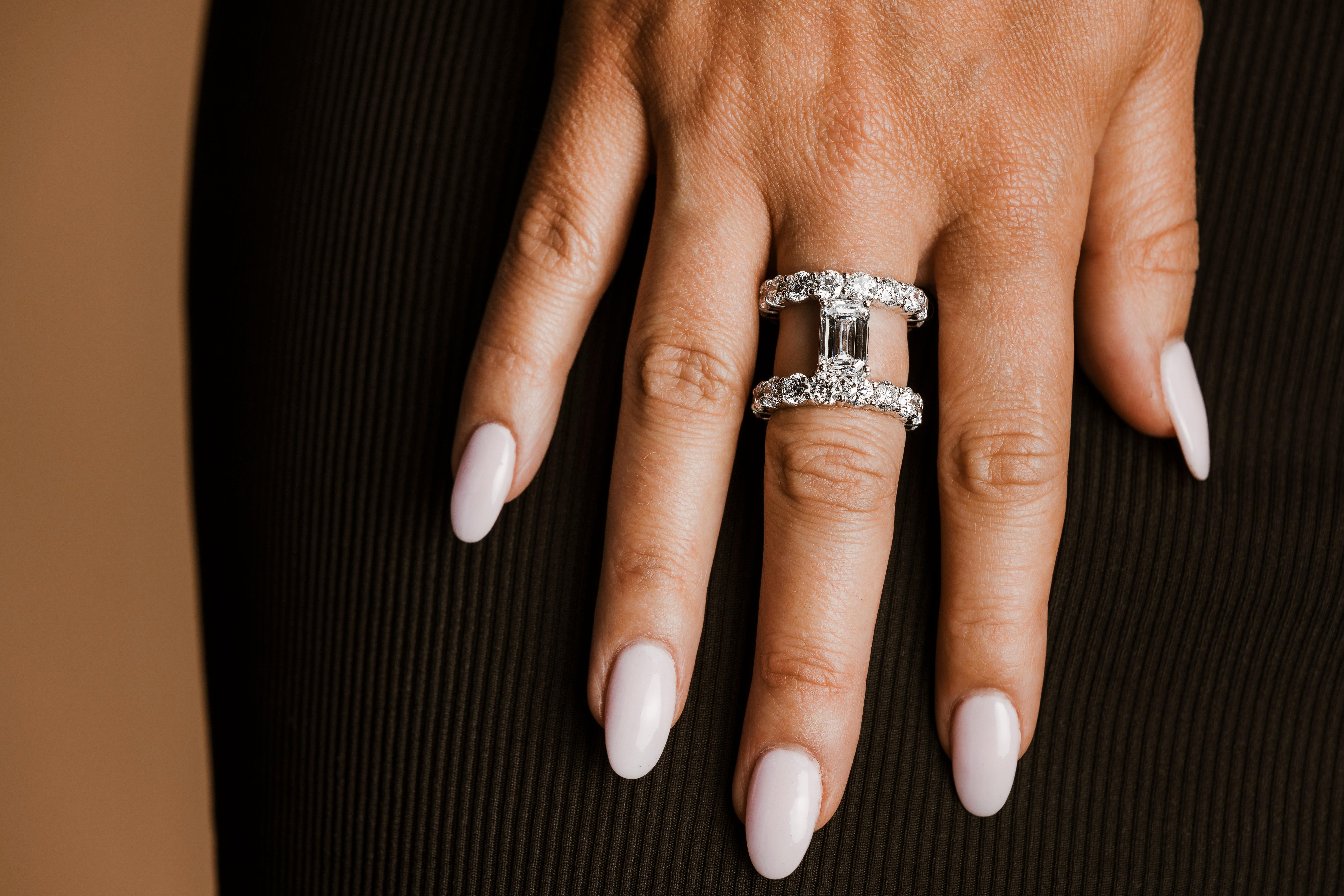 This opulent 18k white gold double eternity ring features a total of 13.82 carats of natural round and emerald cut diamonds. The centerpiece is a GIA certified 3.02-carat diamond with D color and Flawless clarity. The diamonds are rated Excellent